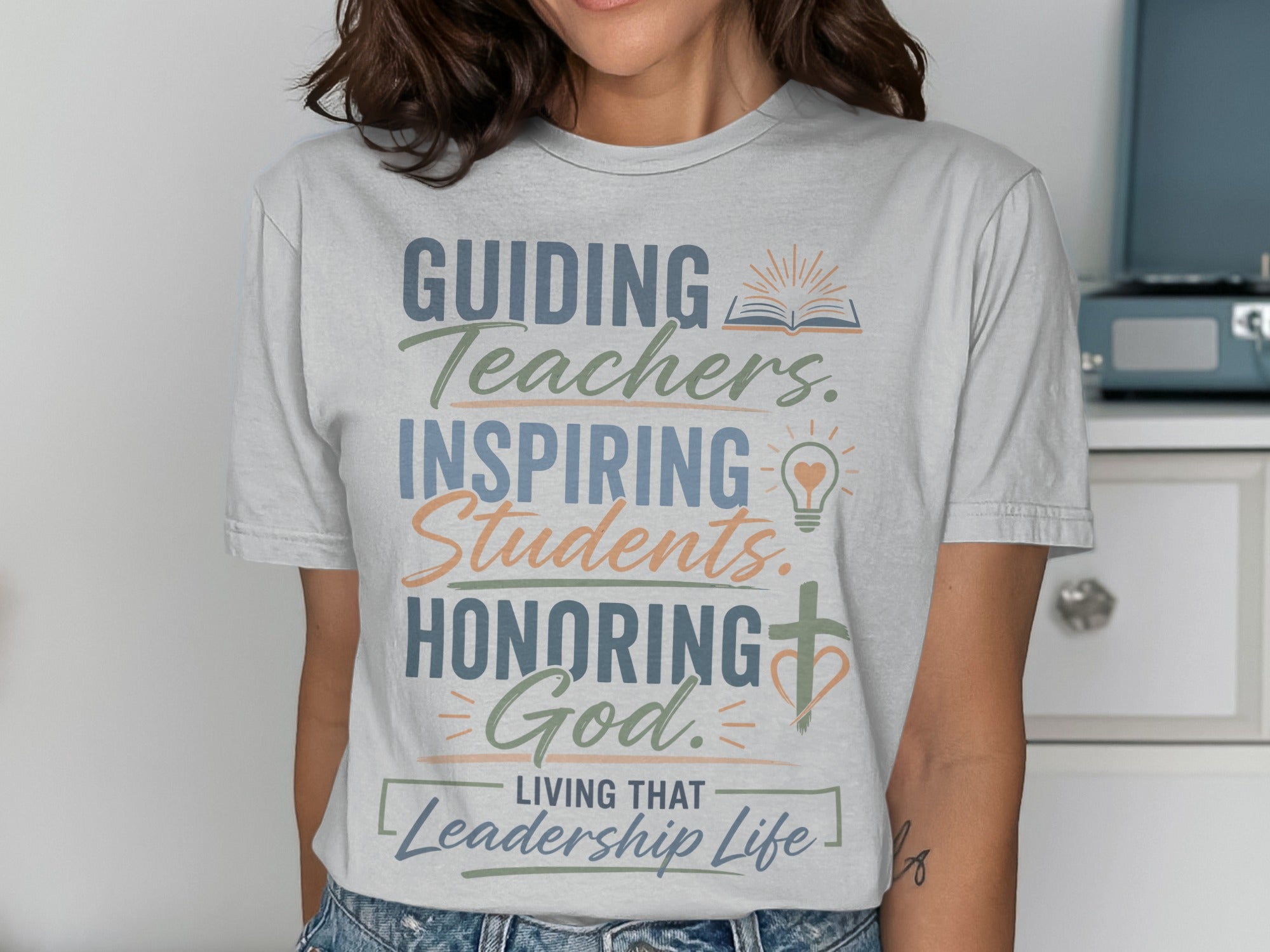 T-shirt with text "Guiding Teachers. Inspiring Students. Honoring God. Living That Leadership Life."