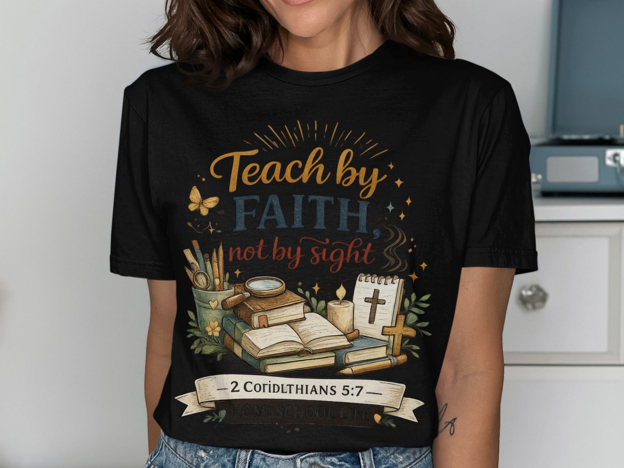 Black t-shirt with "Teach by faith, not by sight" and bible study elements.
