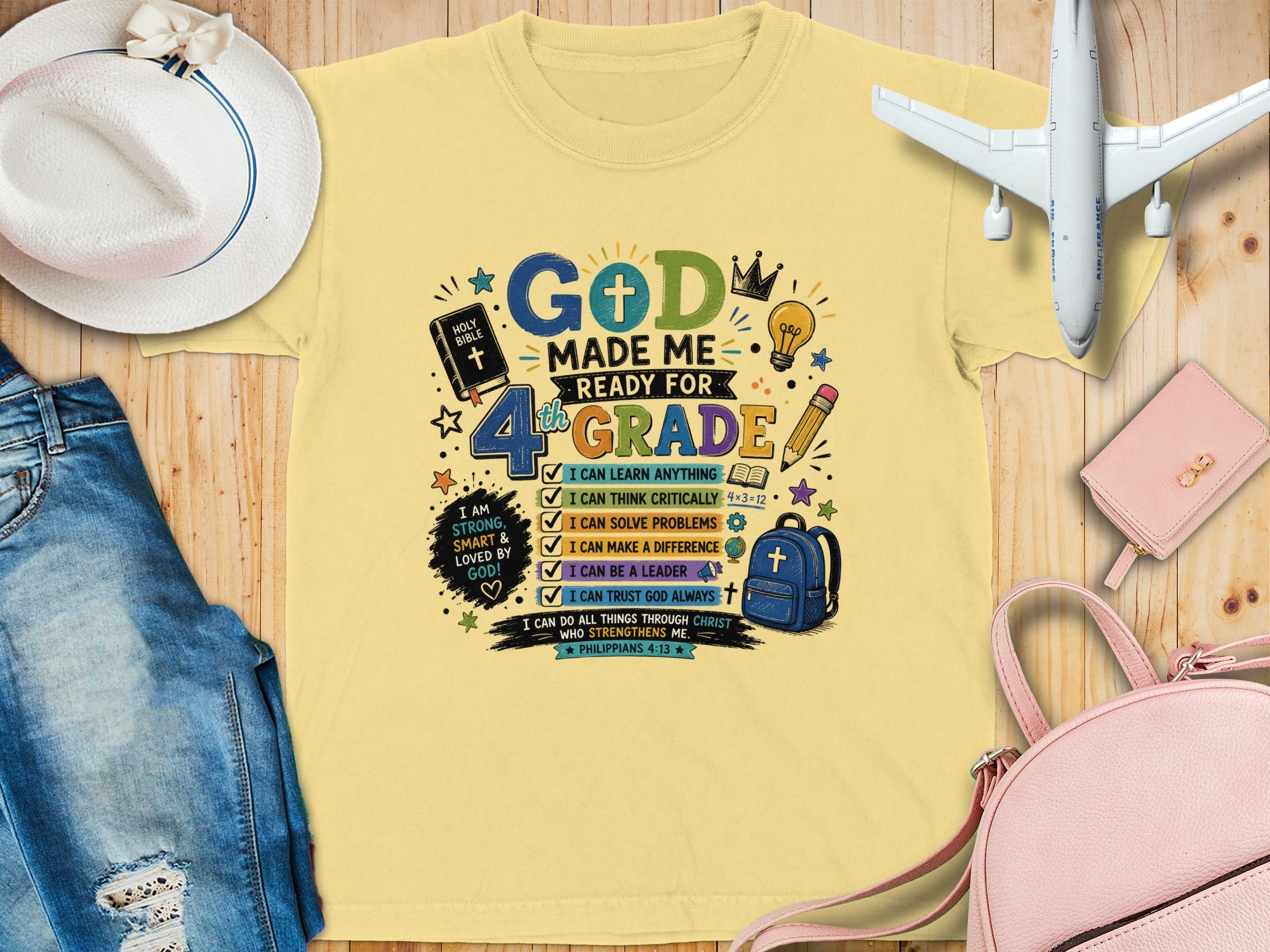 "4th Grade" graphic tee with bible verse, checklist, and school supplies.