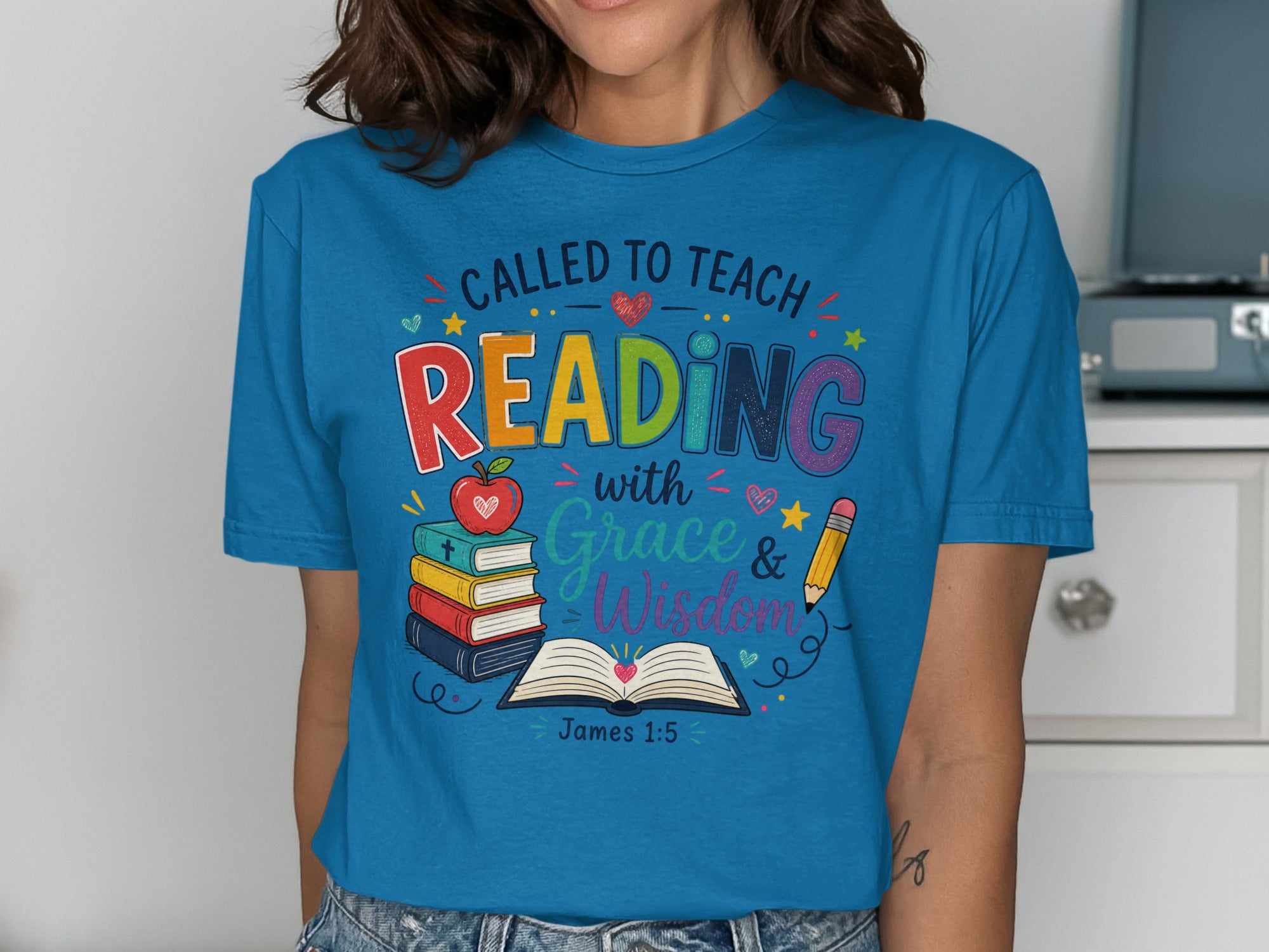 Blue t-shirt with "Called to Teach Reading with Grace & Wisdom" text and school icons.