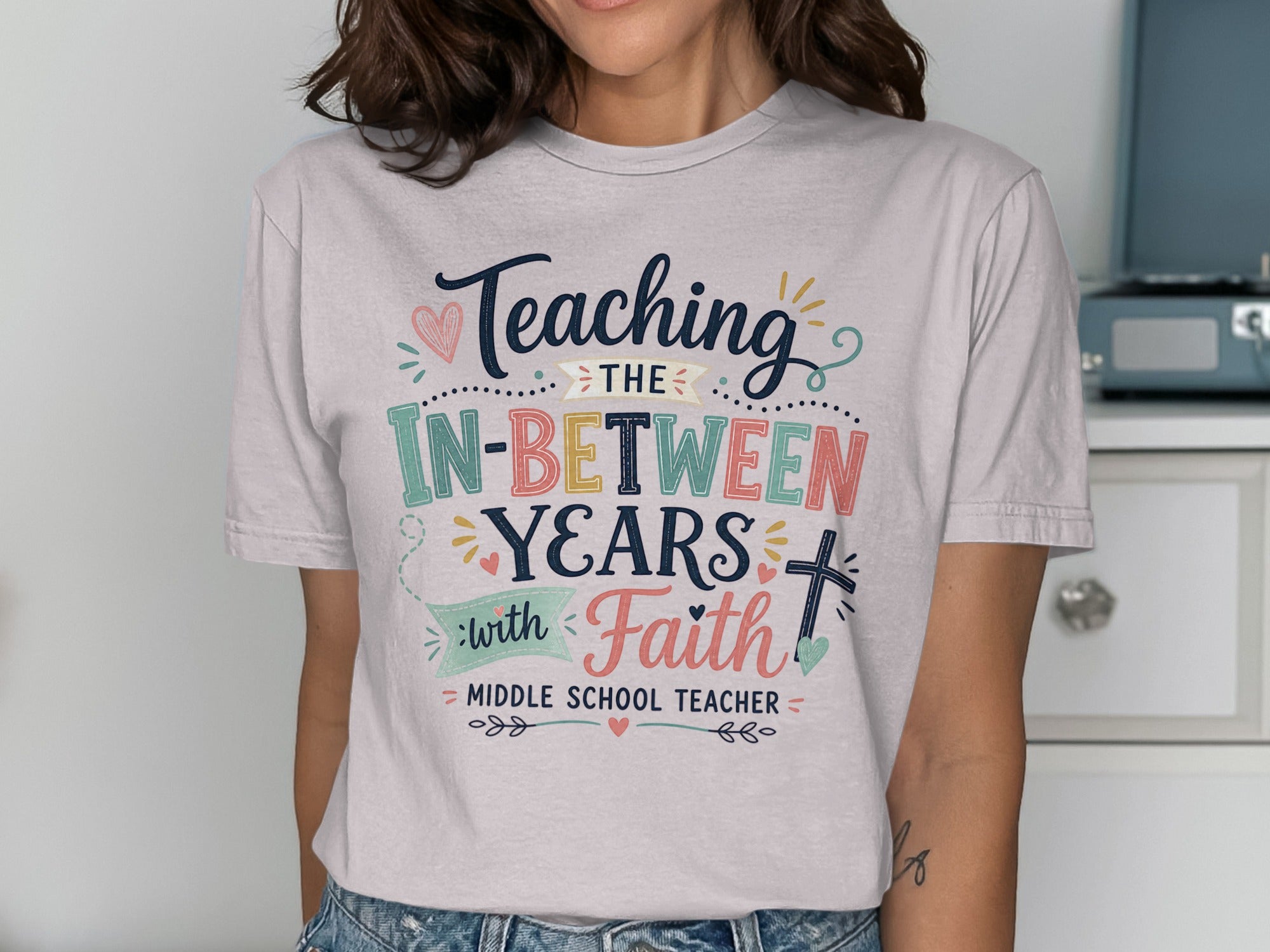 T-shirt with "Teaching the In-Between Years with Faith" text for middle school teachers.