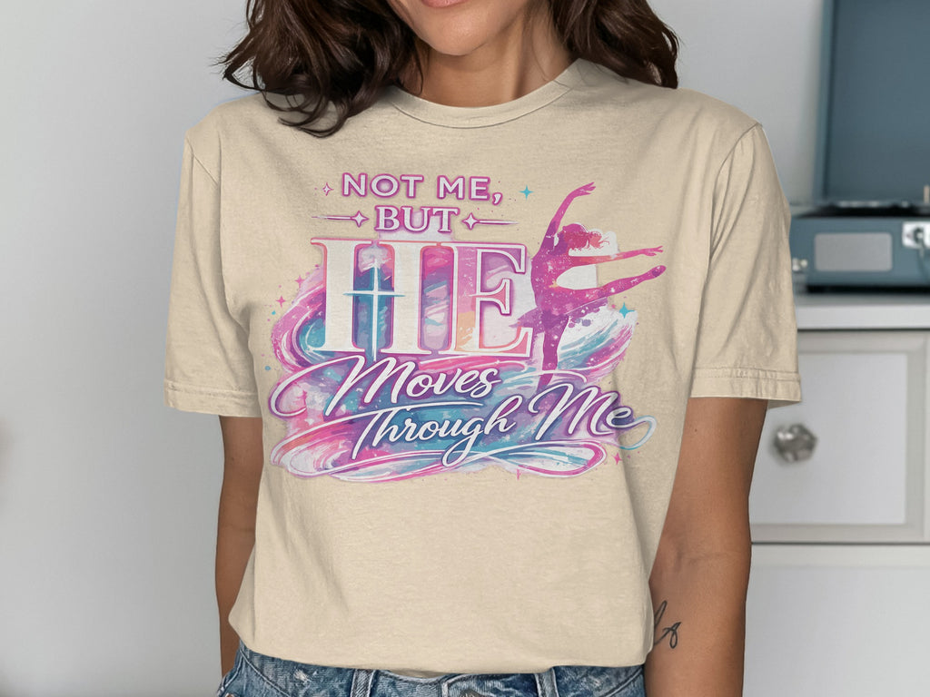 T-shirt with "Not Me, But HE Moves Through Me" and a ballerina design.