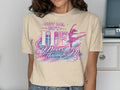 T-shirt with "Not Me, But HE Moves Through Me" and a ballerina design.
