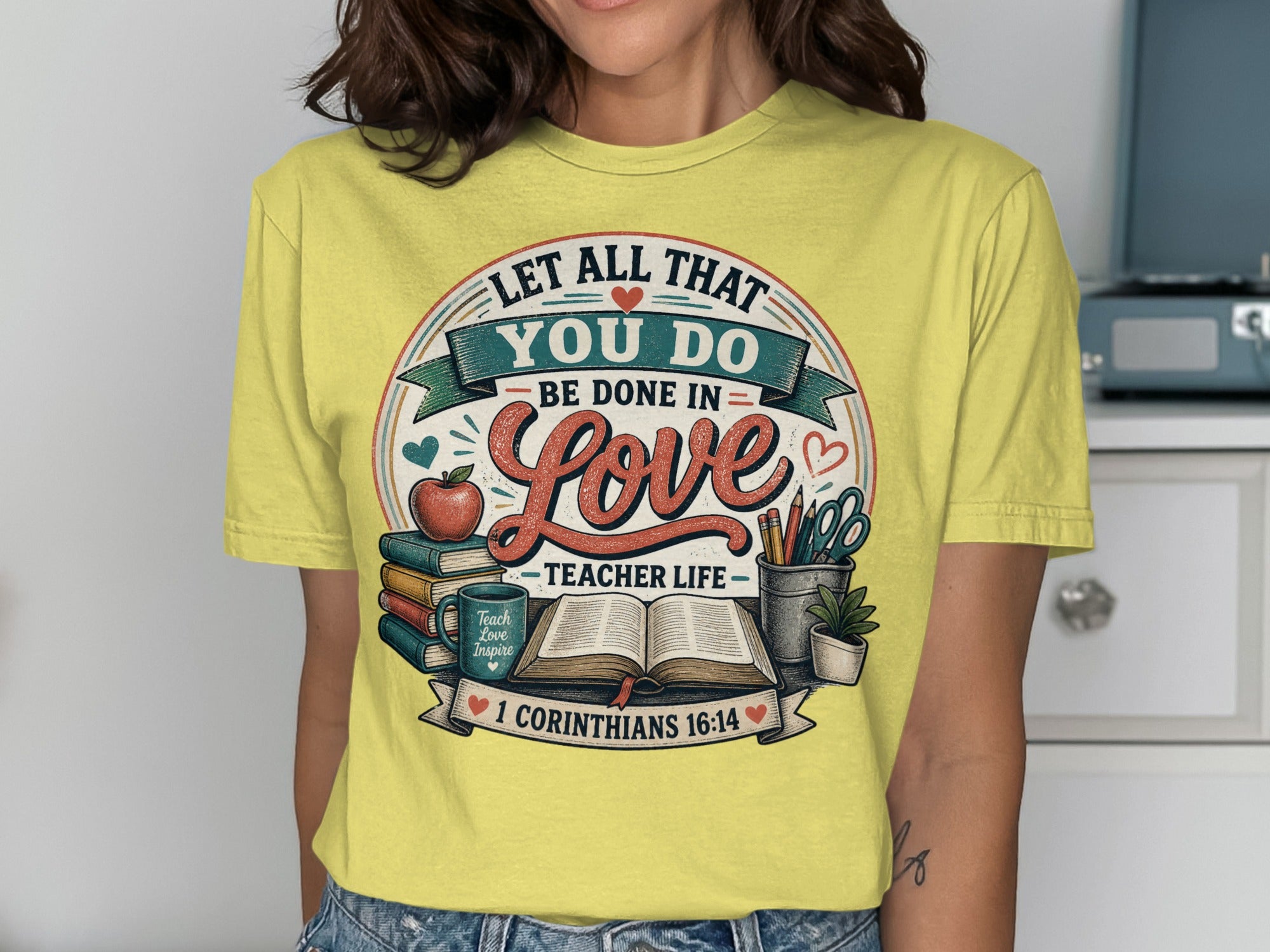 Yellow t-shirt with "Let All That You Do Be Done In Love" and teacher life graphic.