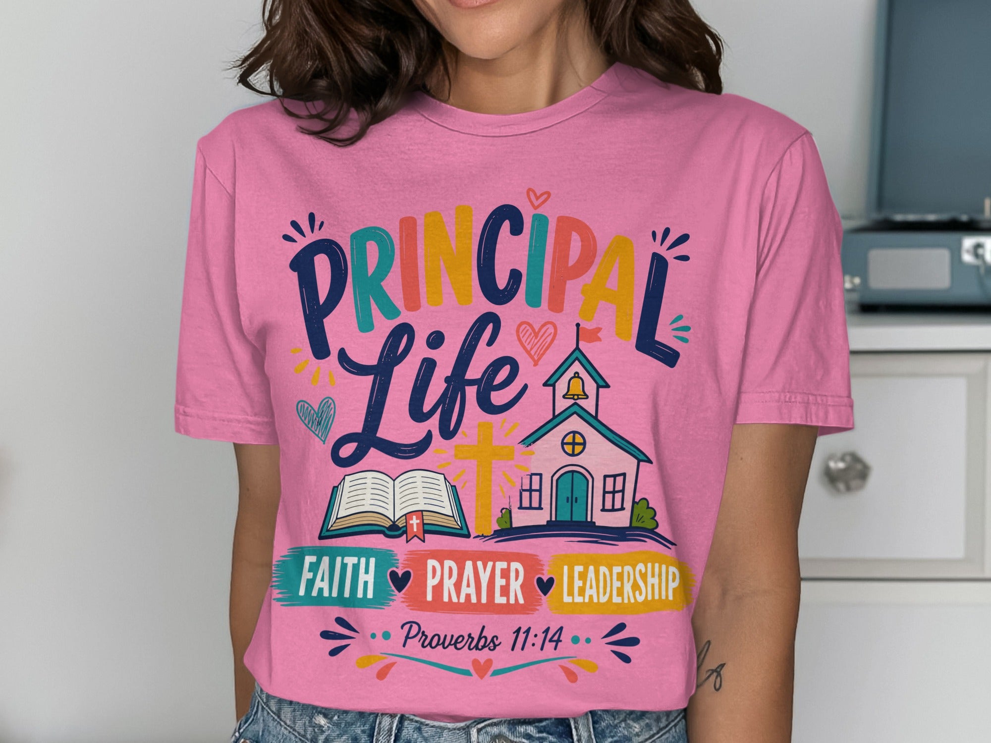 Pink t-shirt with "Principal Life" and "Faith Prayer Leadership" text.