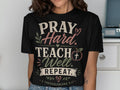 Black t-shirt with "PRAY. Hard. TEACH. Well. REPEAT." and bible verse.