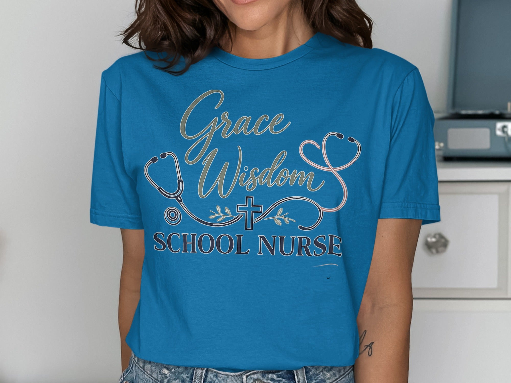 Blue t-shirt with "Grace Wisdom School Nurse" and stethoscope design.