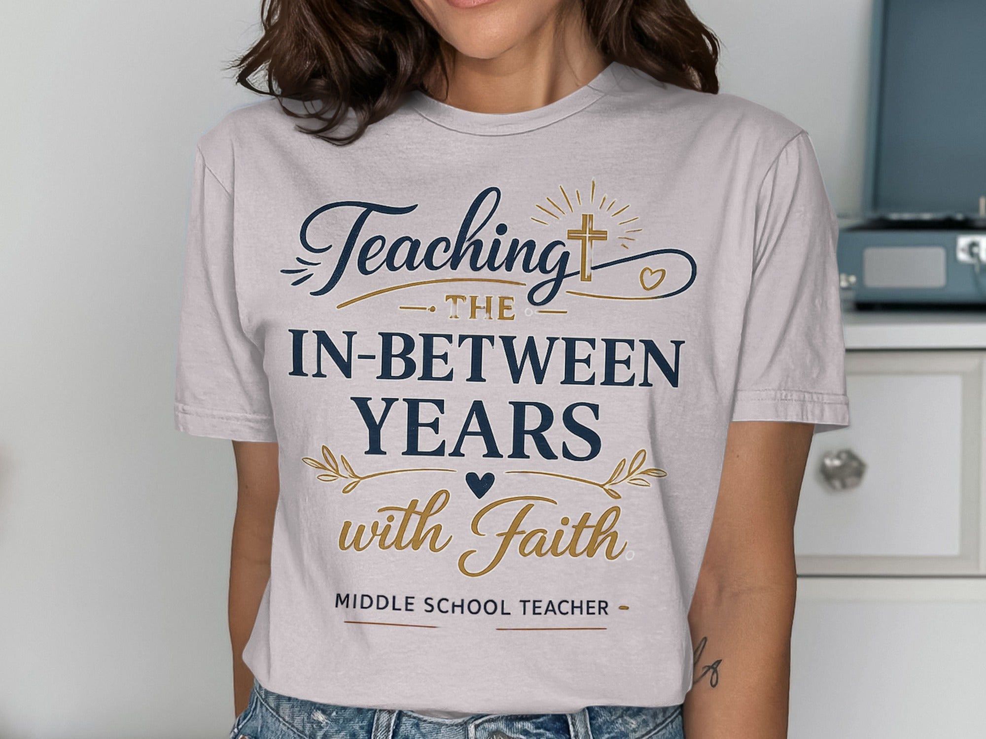 T-shirt with "Teaching the in-between years with faith" text.