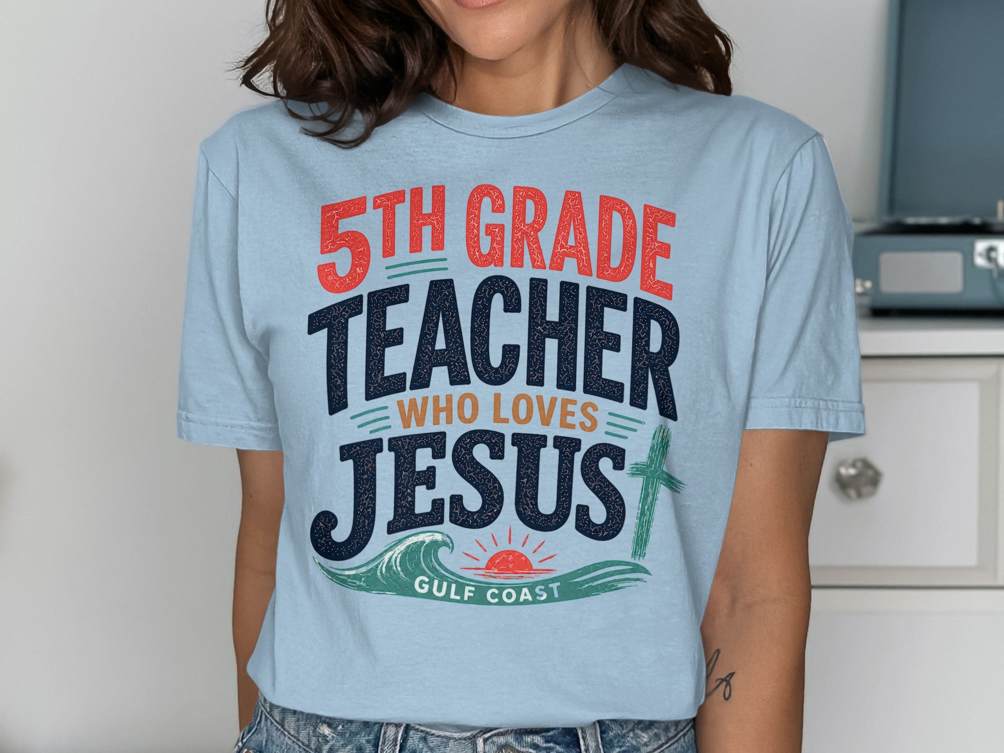 5th Grade Teacher Who Loves Jesus t-shirt with Gulf Coast text and cross.