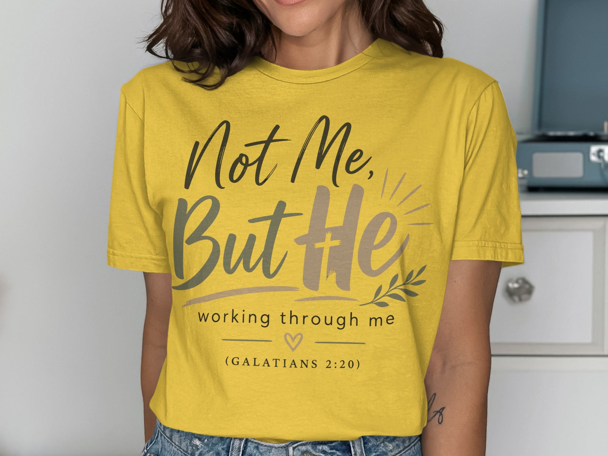Yellow t-shirt with "Not Me, But He" and "Galatians 2:20" text.