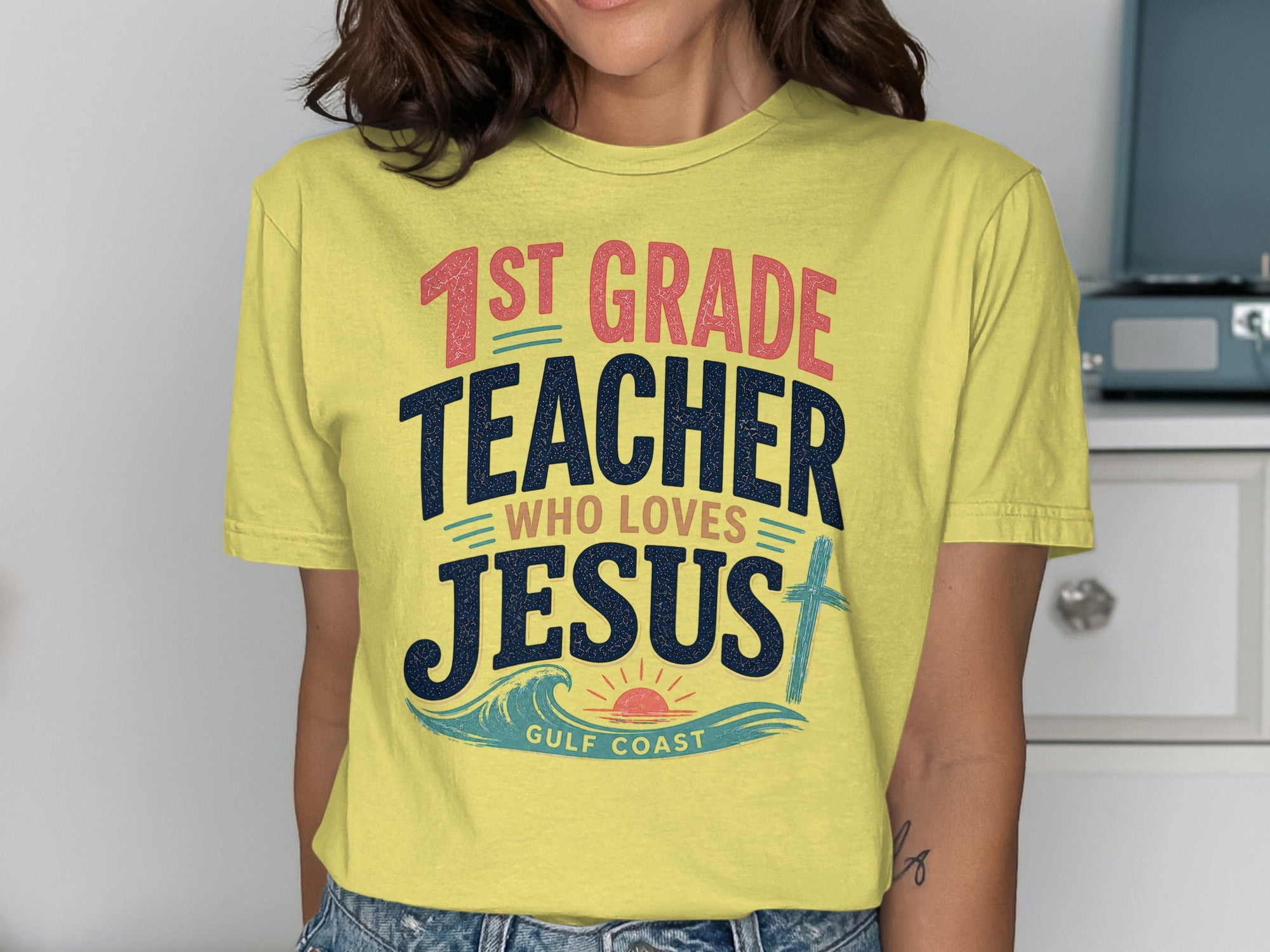 Yellow t-shirt with "1st GRADE TEACHER WHO LOVES JESUS" and "GULF COAST."