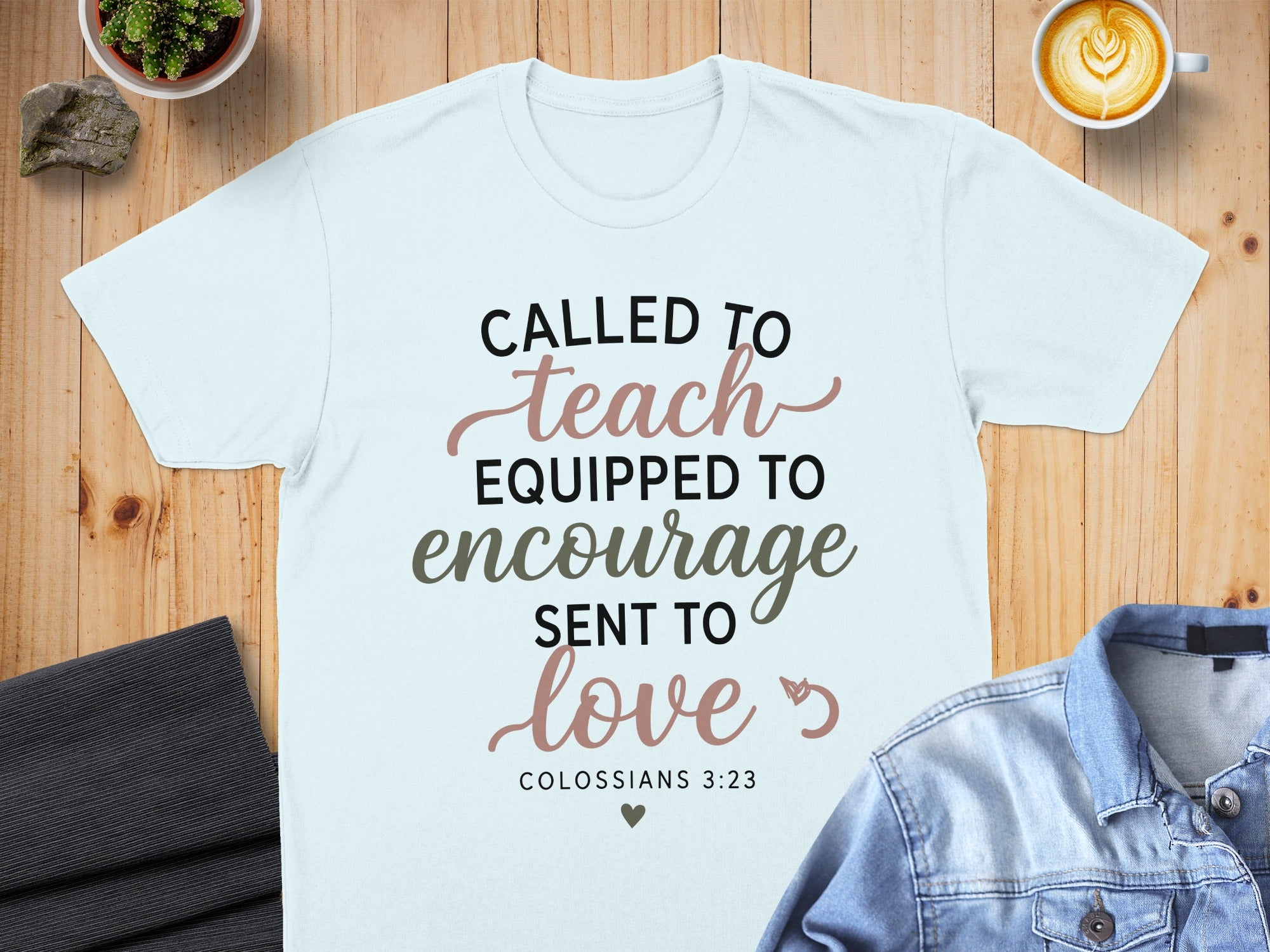 Light blue t-shirt with "Called to teach, equipped to encourage, sent to love" and Bible verse.