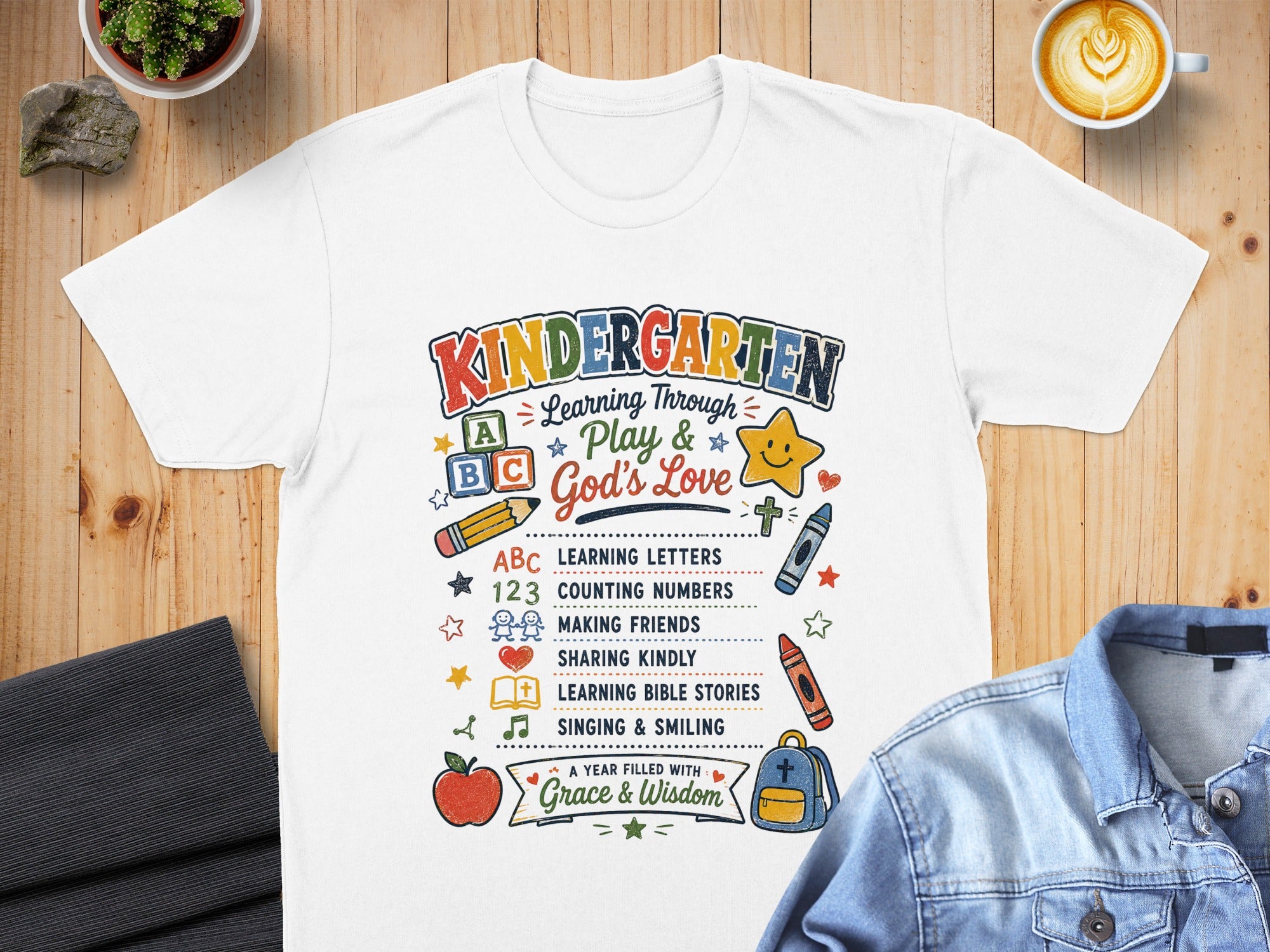 Kindergarten t-shirt with ABCs, numbers, and learning icons, reads "Grace & Wisdom".
