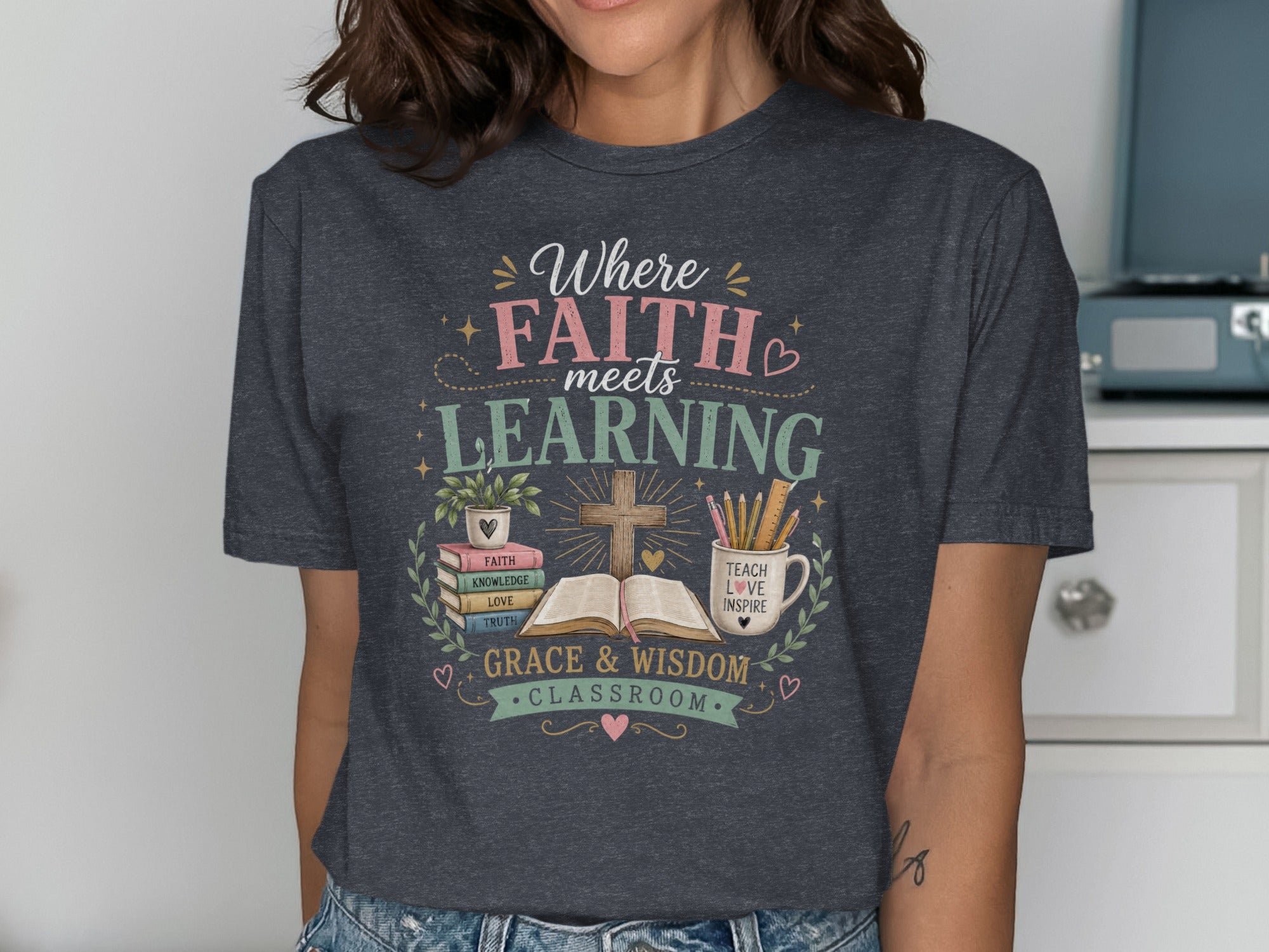 T-shirt with "Where FAITH meets LEARNING" and classroom motifs.