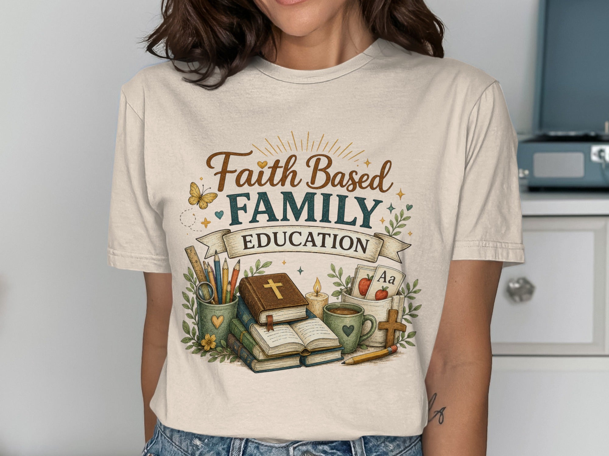 T-shirt with "Faith Family Education" text and school supplies.