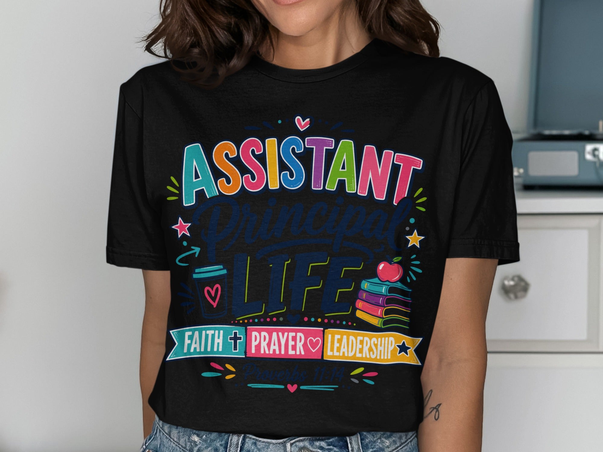Black t-shirt with colorful "Assistant Principal Life" graphic and Bible verse reference.