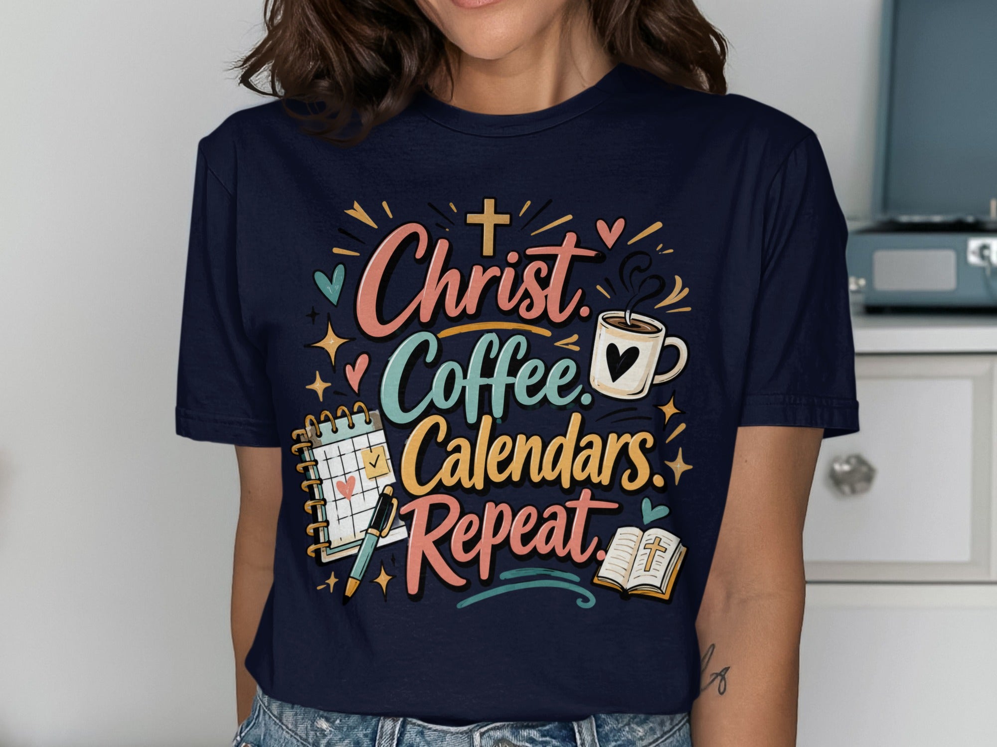 T-shirt with "Christ. Coffee. Calendars. Repeat." slogan and graphic elements.