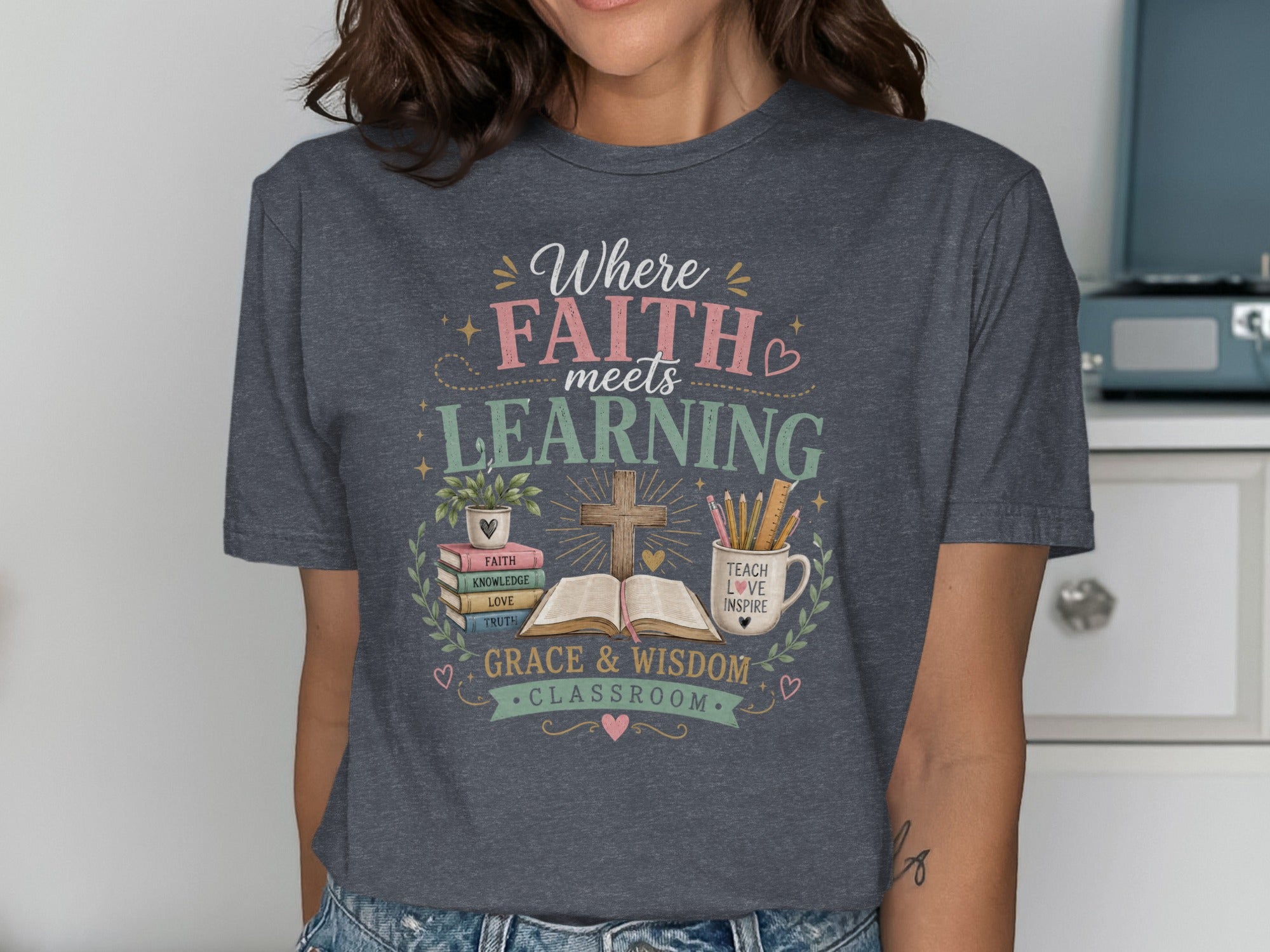 T-shirt with "Where FAITH meets LEARNING" and classroom-themed graphics.