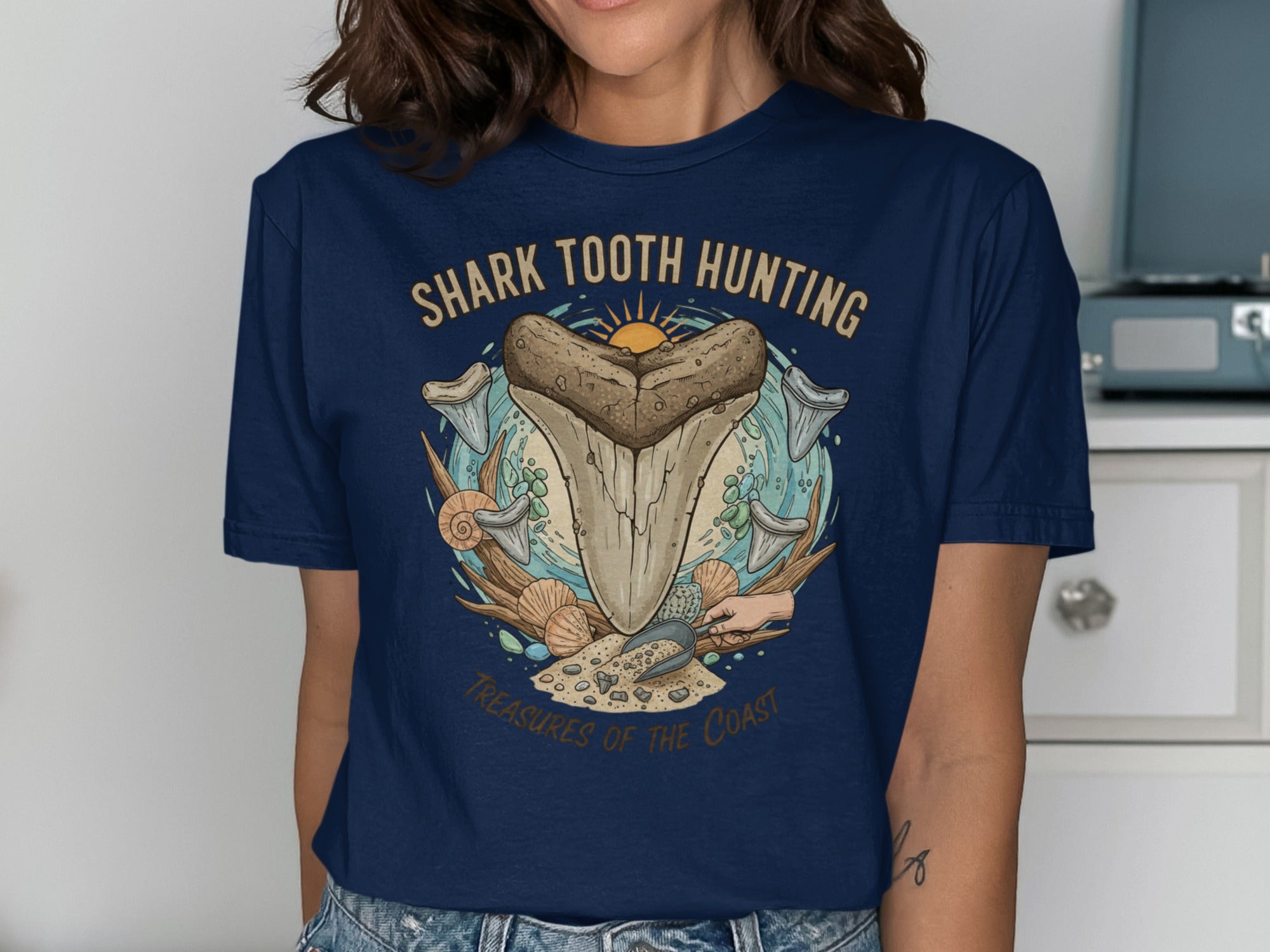 Navy t-shirt with "Shark Tooth Hunting Treasures of the Coast" graphic.