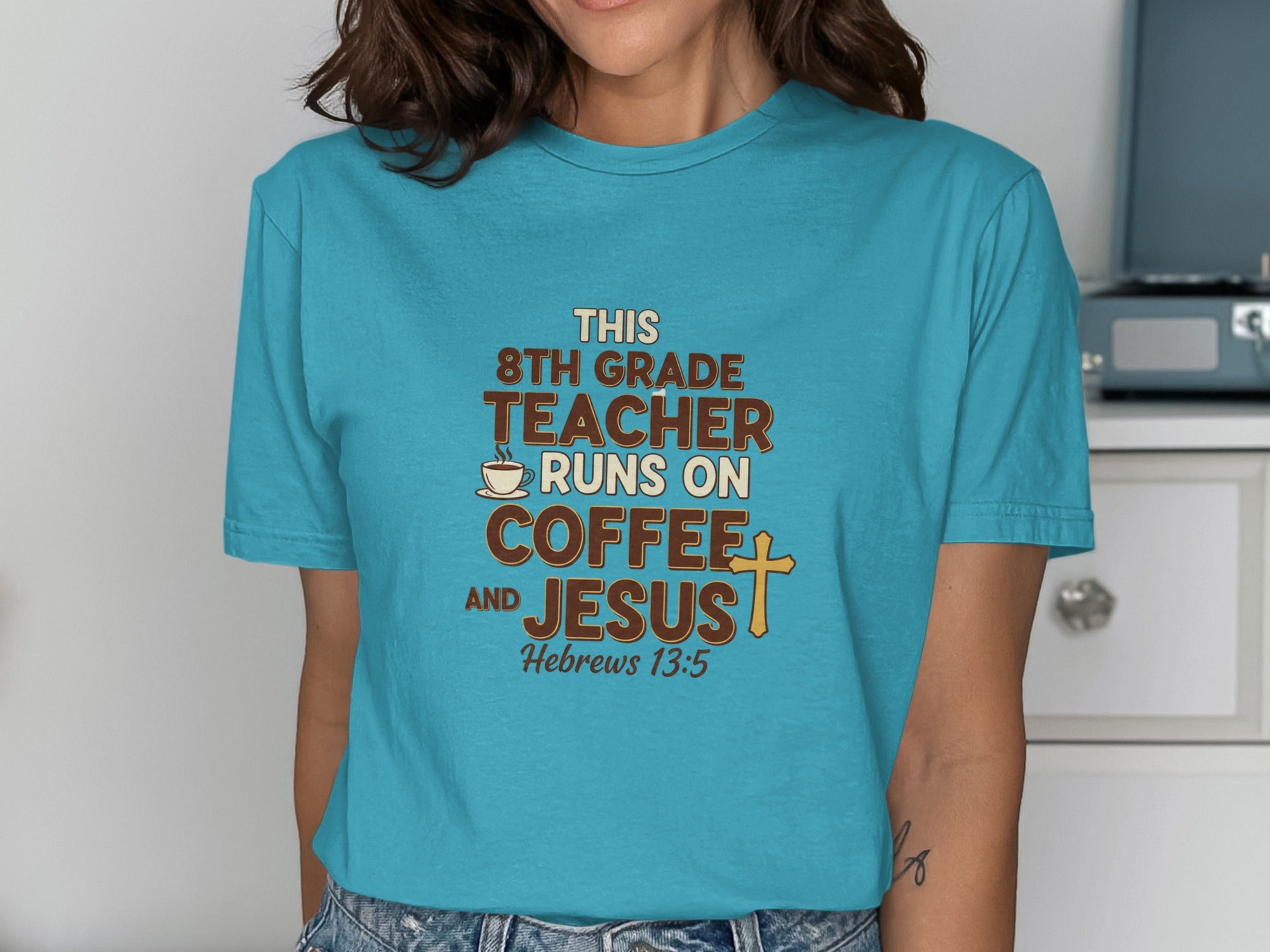 Turquoise t-shirt with text "8th grade teacher runs on coffee and Jesus" and bible verse.