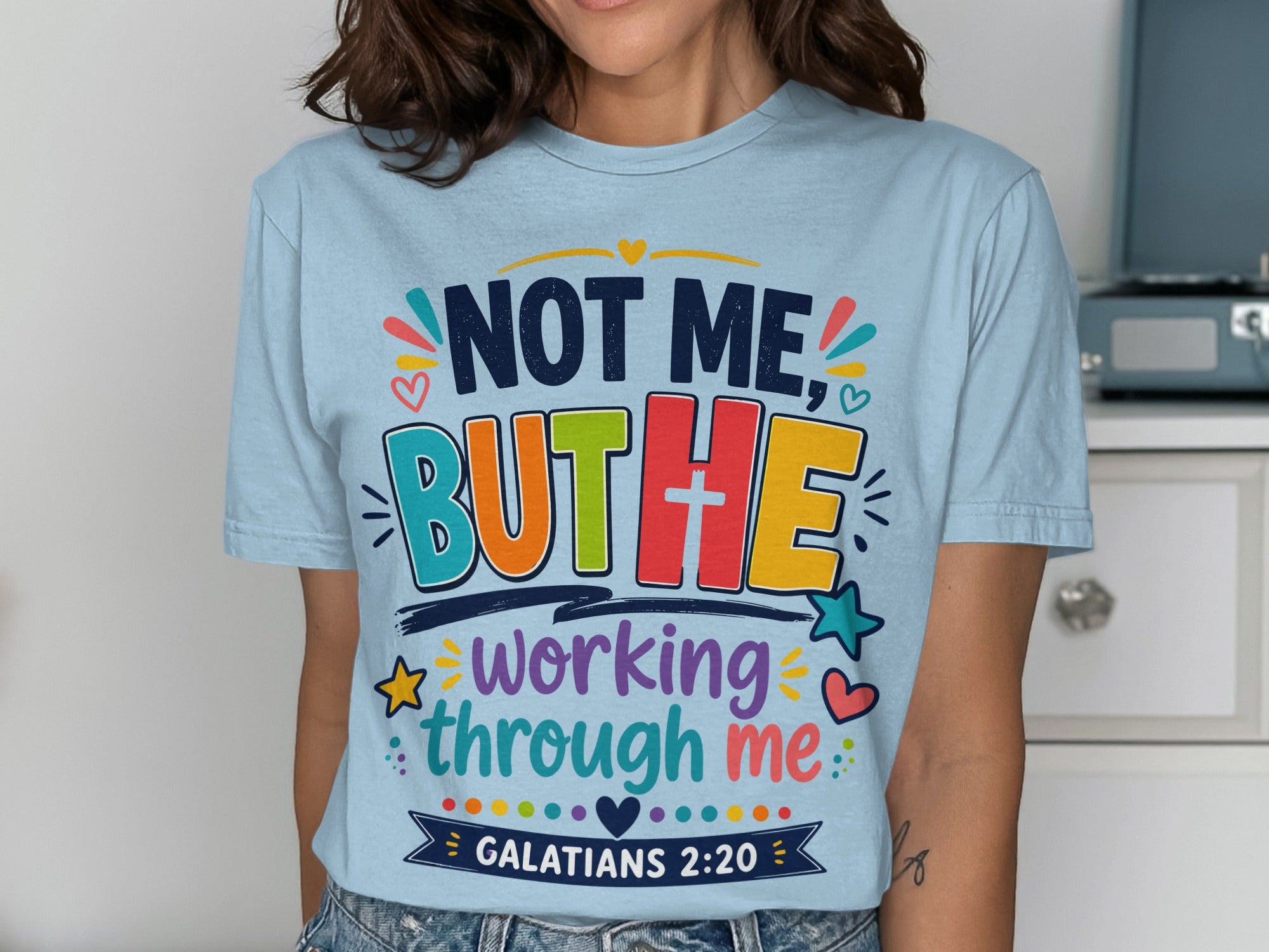 Light blue t-shirt with "NOT ME, BUT HE working through me GALATIANS 2:20" text.
