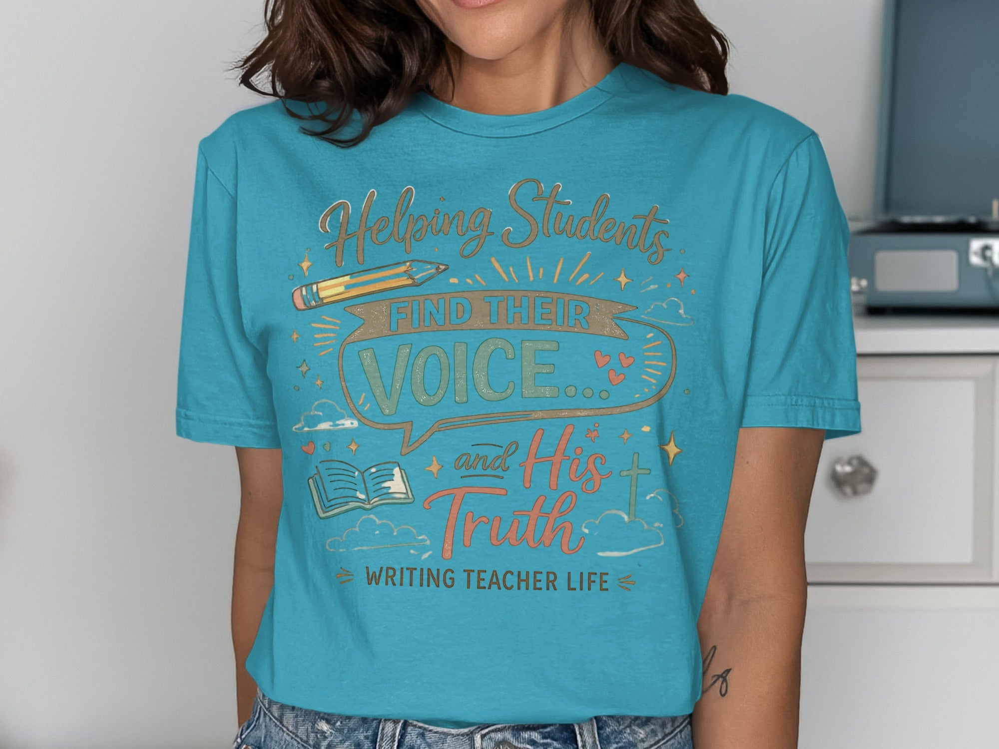 Teal t-shirt with "Helping Students Find Their Voice and His Truth Writing Teacher Life" text.