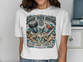 Graphic t-shirt with "Shark Tooth Hunting" and "Gulf Coast Florida" text, featuring shark teeth.