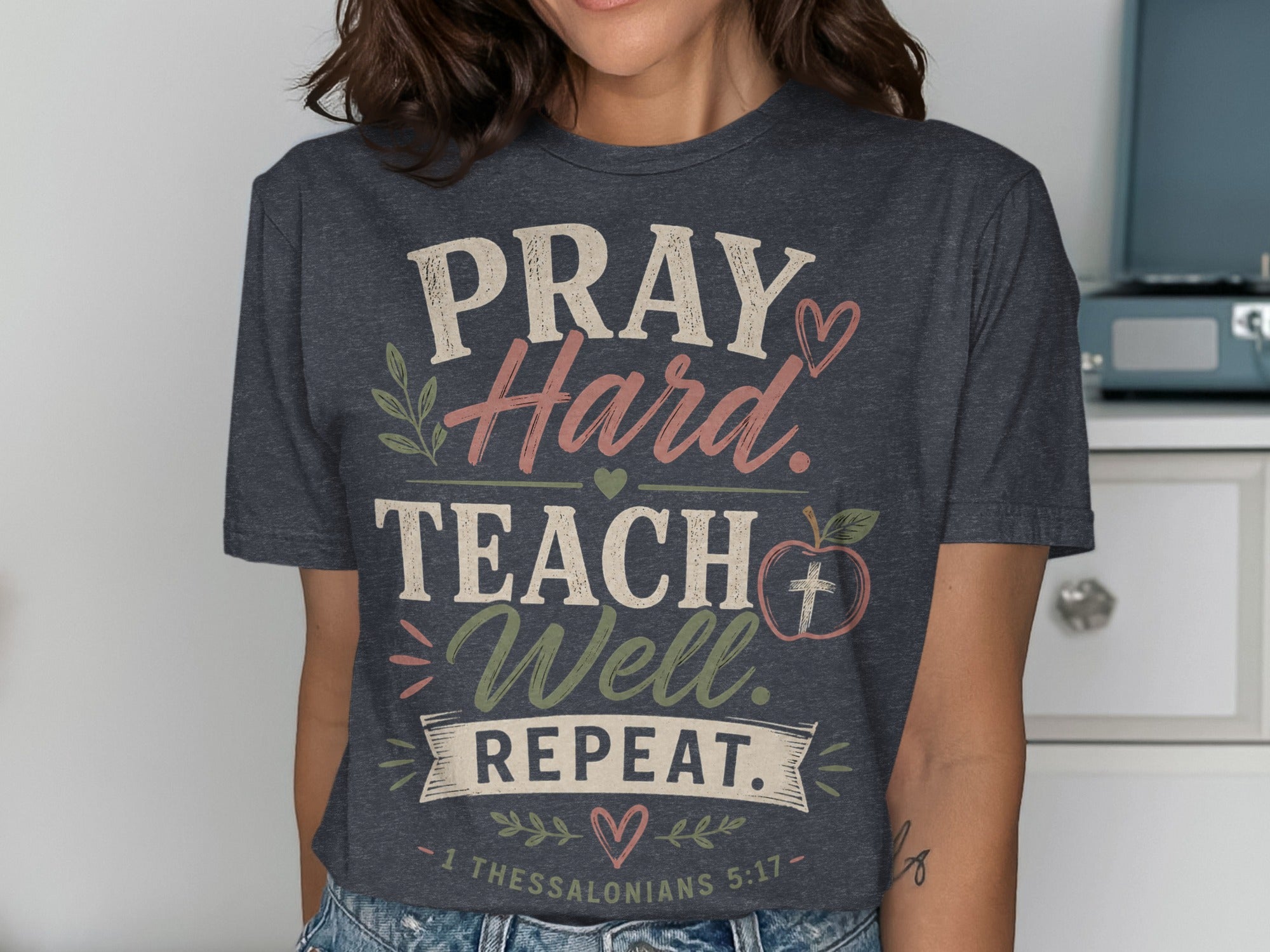Dark gray t-shirt with PRAY Hard. TEACH Well. REPEAT. 1 Thessalonians 5:17.