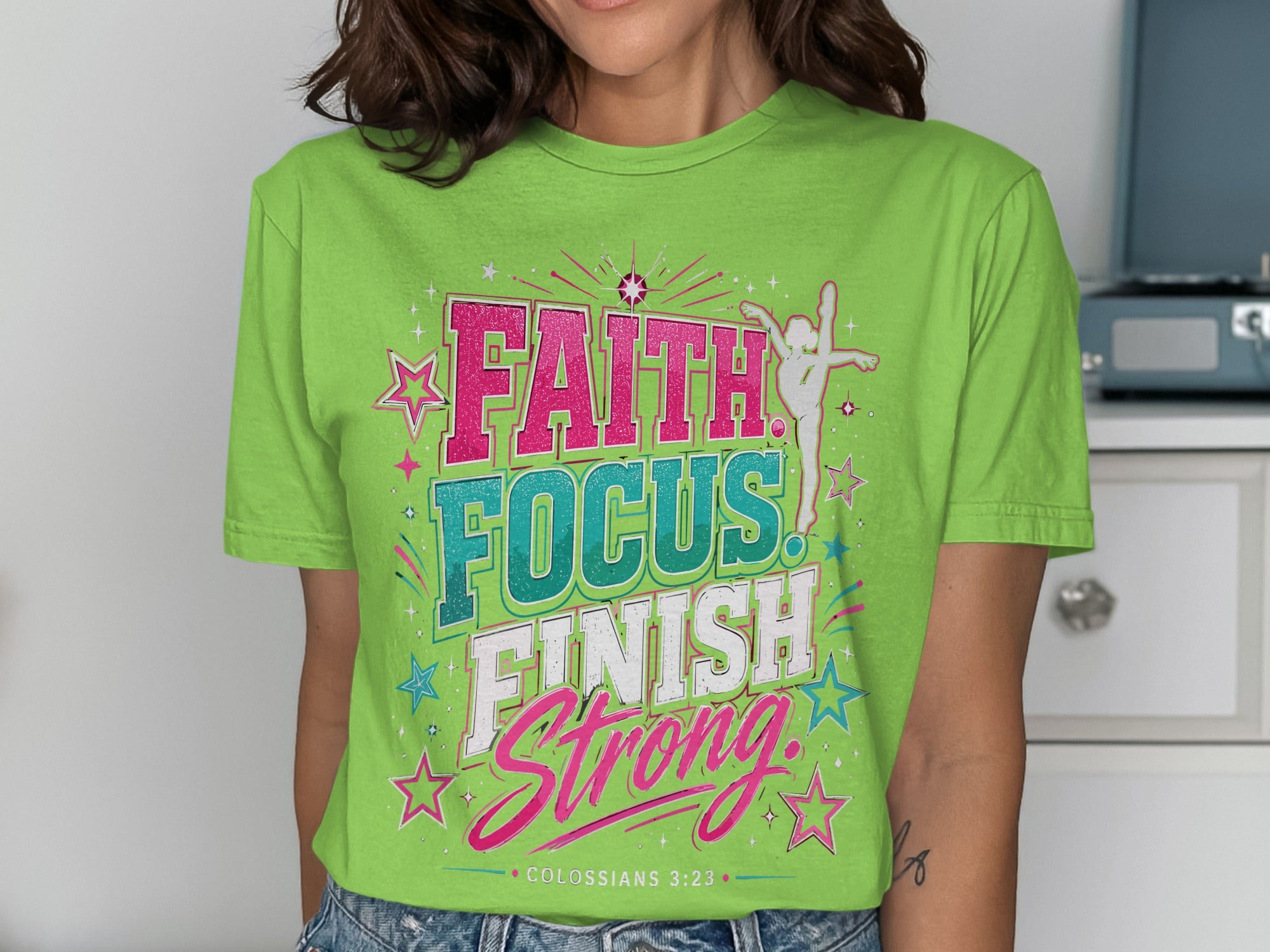 Green t-shirt with "Faith Focus Finish Strong" text and stars.