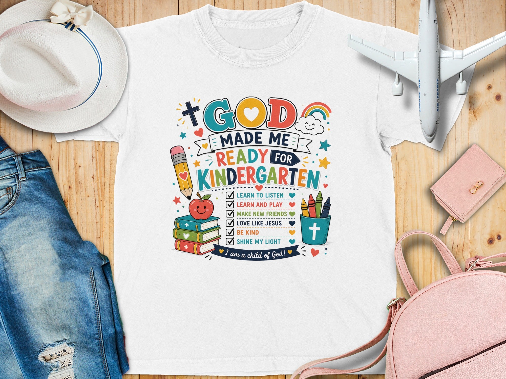 T-shirt with "God Made Me Ready for Kindergarten" text and school-themed icons.