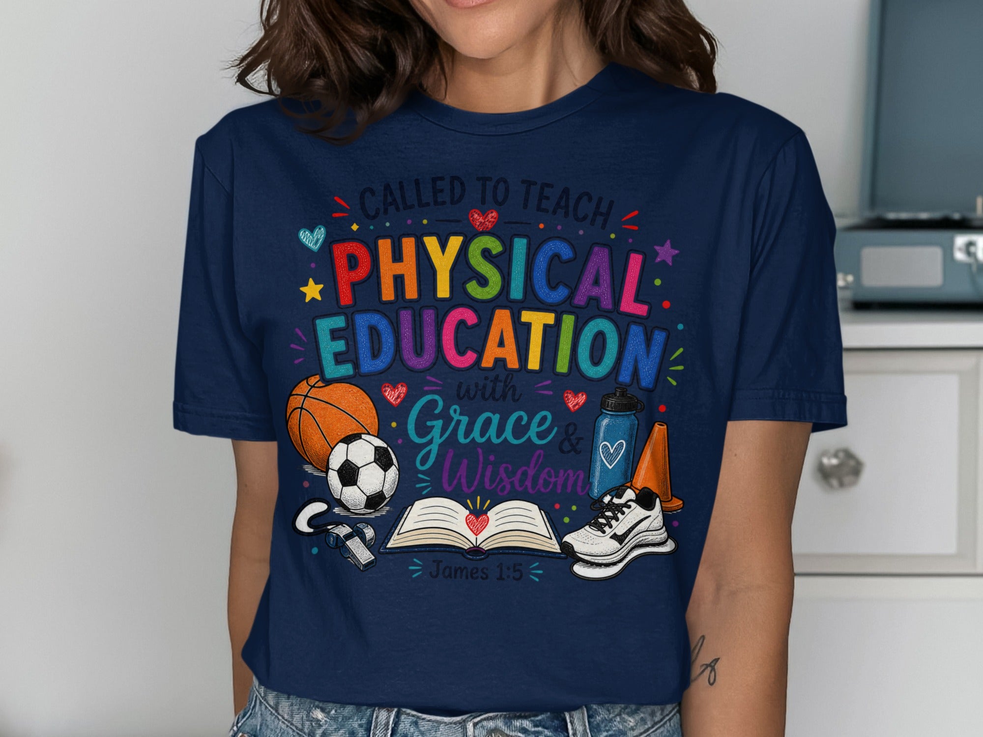 T-shirt with "Called to Teach Physical Education with Grace & Wisdom" and sports items.