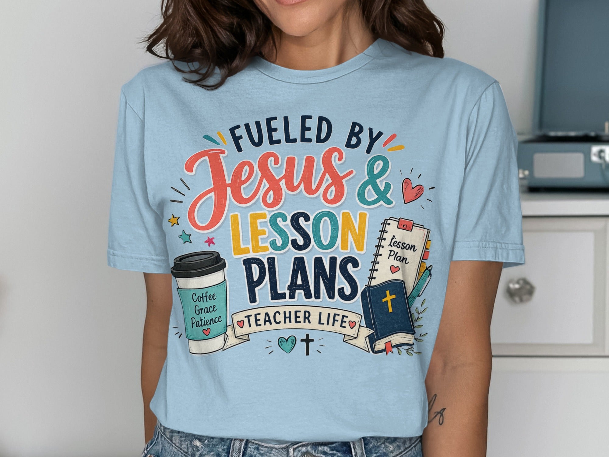 "Fueled by Jesus & Lesson Plans" t-shirt with coffee and book icons.