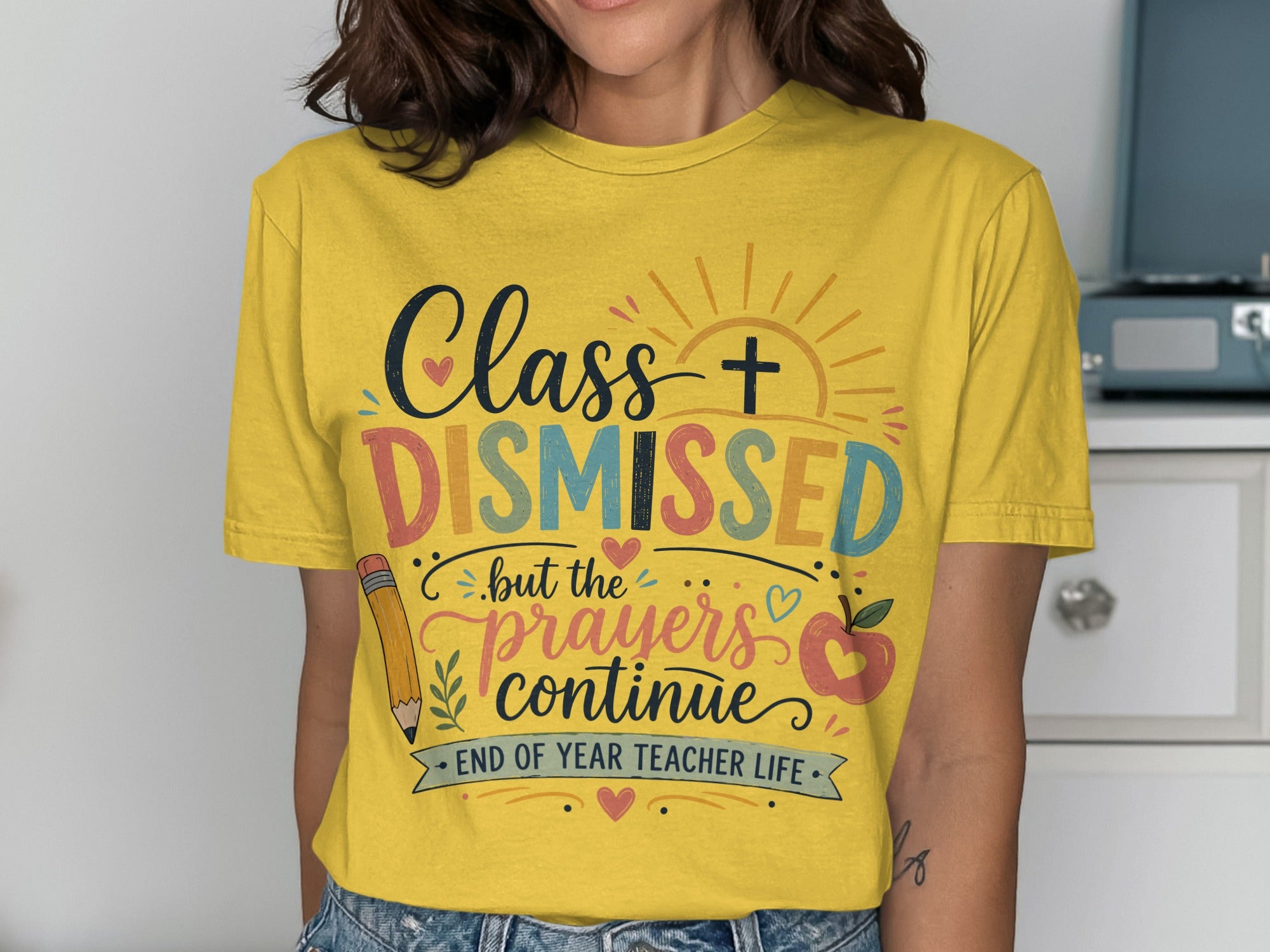 T-shirt with "Class DISMISSED but the prayers continue" text and teacher graphics.