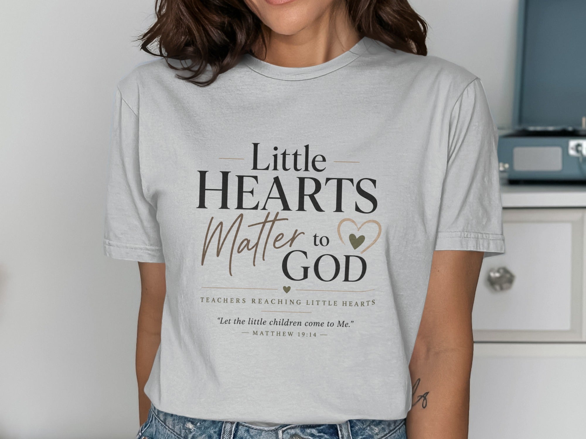 Light gray t-shirt with "Little Hearts Matter to God" text and Bible verse.