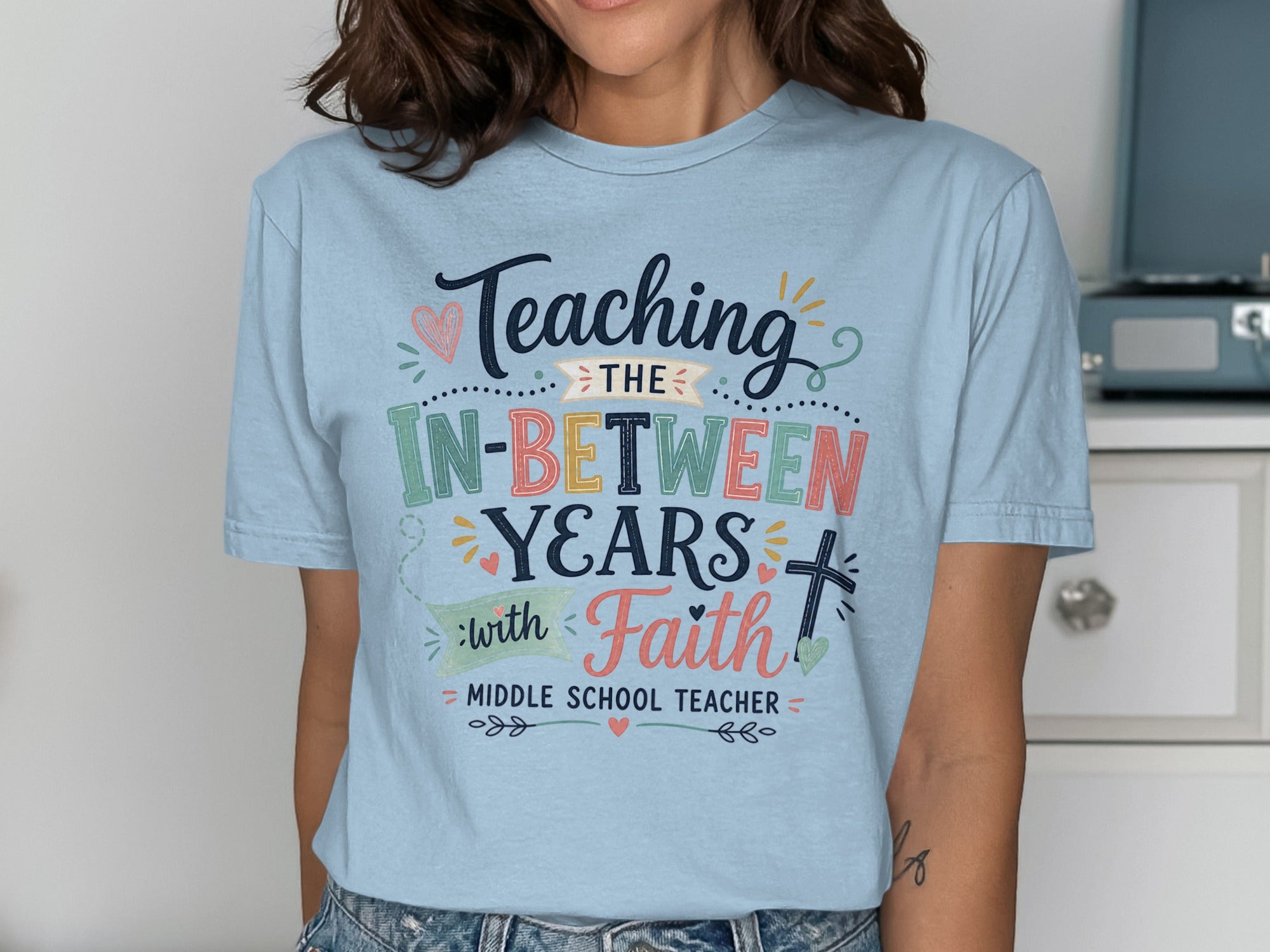 Light blue t-shirt with "Teaching In-Between Years with Faith" for Middle School Teacher.