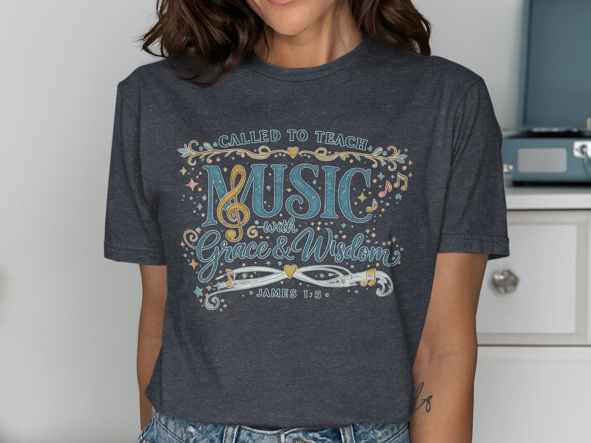 Dark grey t-shirt with "Called to Teach Music with Grace & Wisdom" text.