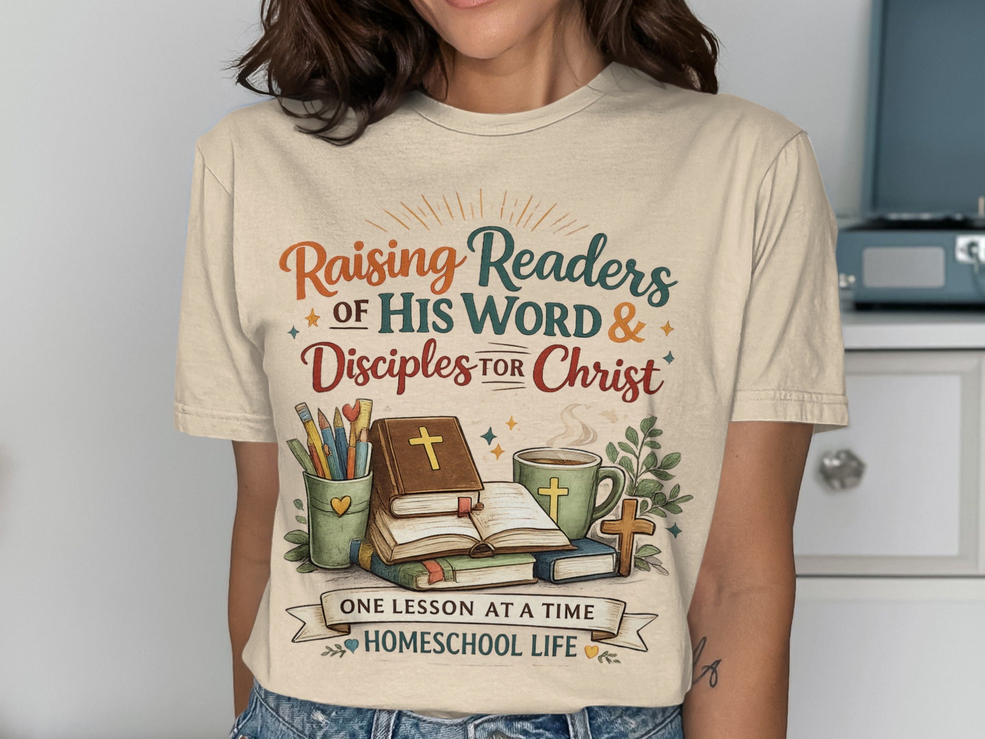 T-shirt with "Raising Readers of His Word & Disciples for Christ" text, books, and cross.