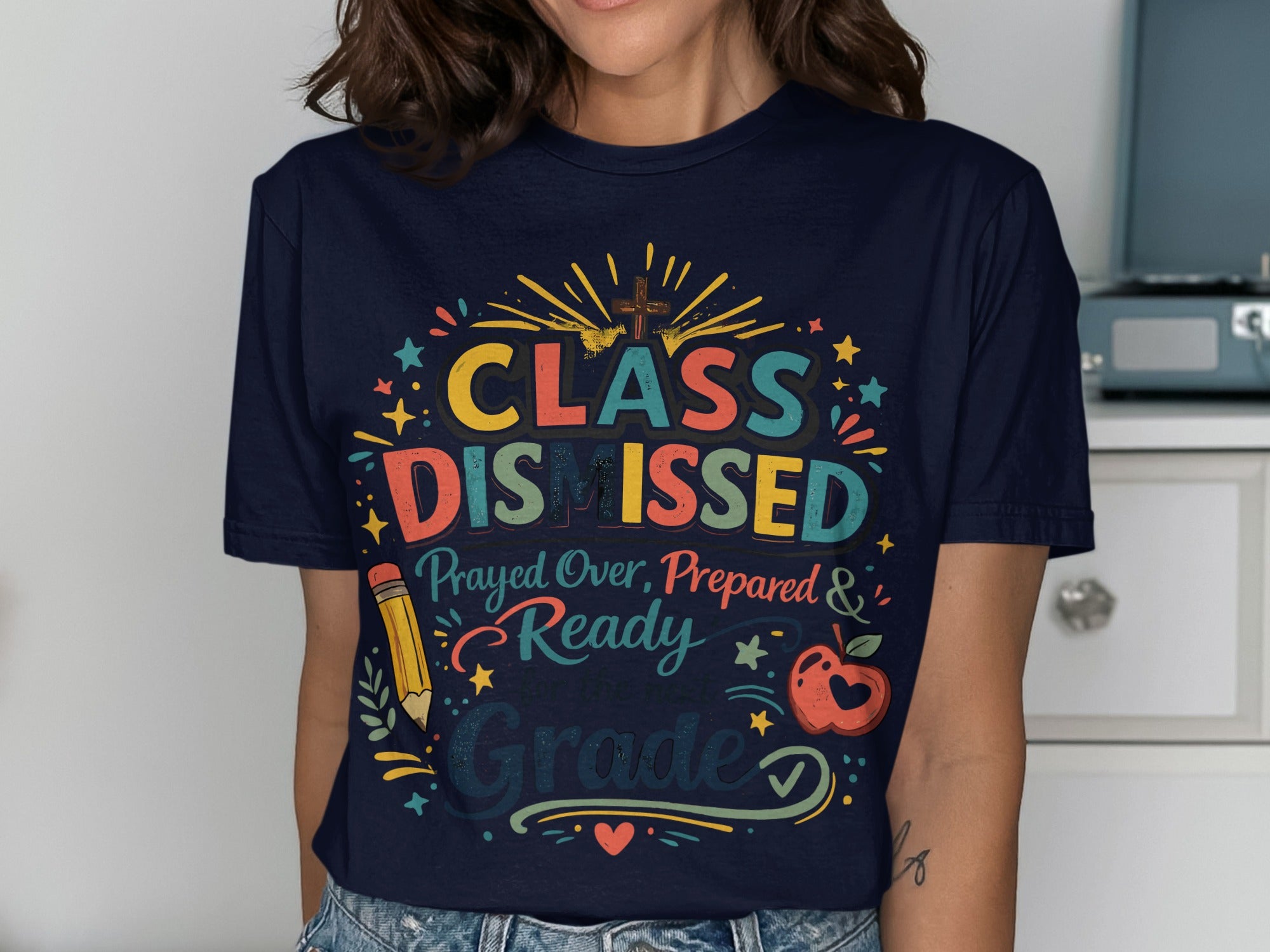 Navy t-shirt with colorful "Class Dismissed" text and school-themed graphics.