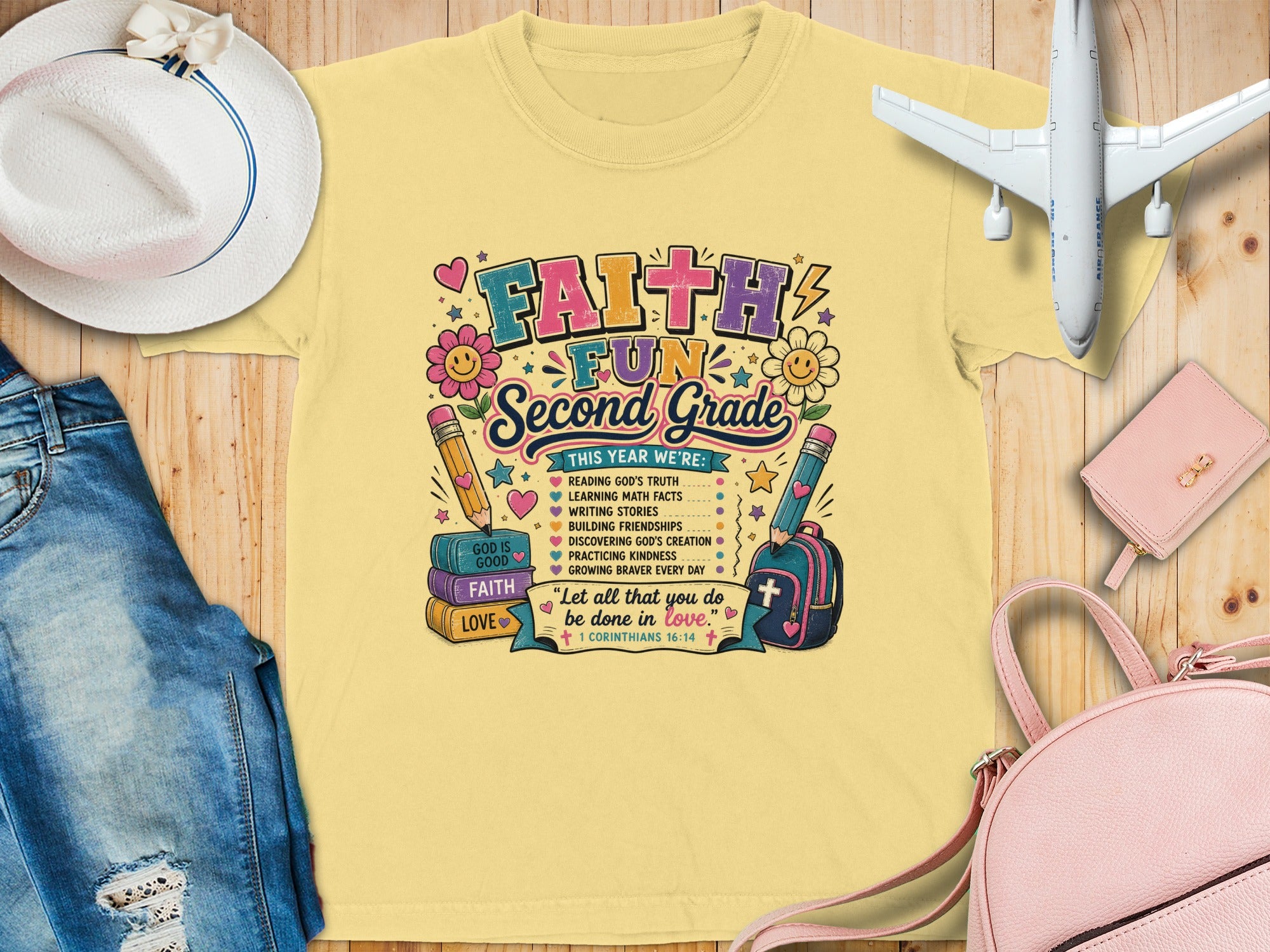 Yellow t-shirt with "Faith Second Grade" and school-themed graphics.