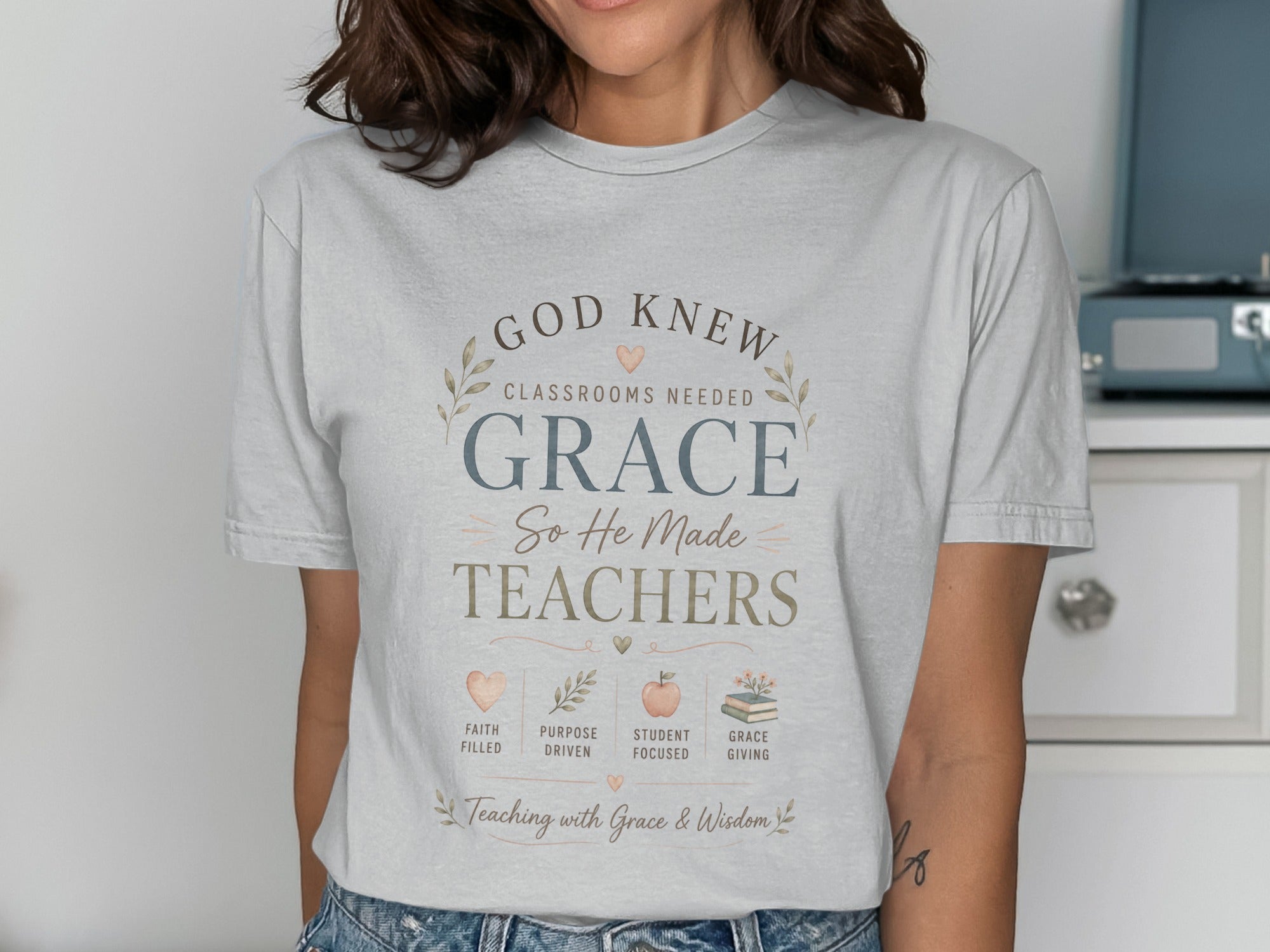 T-shirt with "God Knew Classrooms Needed Grace, So He Made Teachers" and four icons.