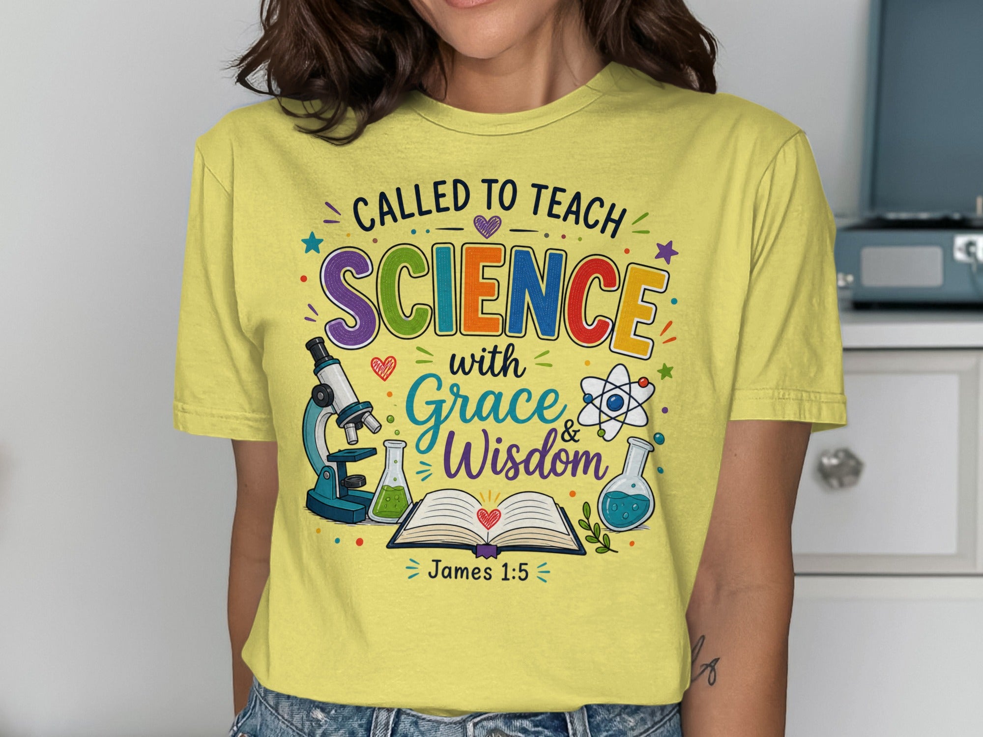 Yellow t-shirt with "Called to Teach Science with Grace & Wisdom James 1:5" and science icons.