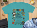 Teal t-shirt with "3rd Grade: Exploring God's World" and school-themed graphics.
