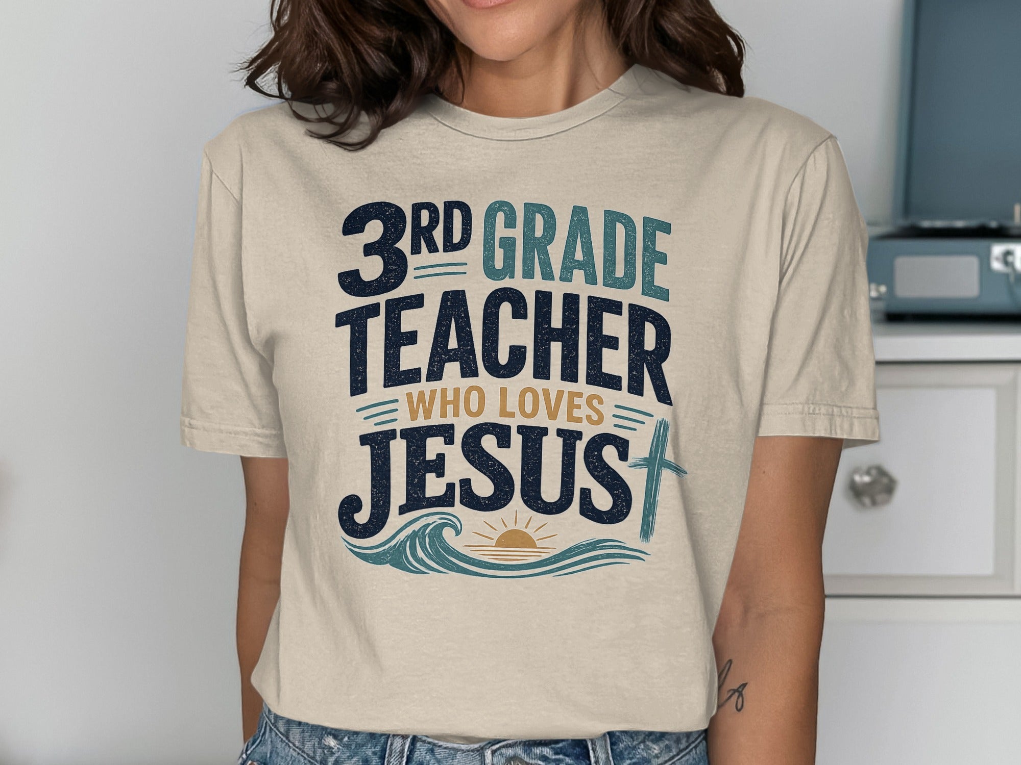 3rd Grade Teacher Who Loves Jesus text with waves and a cross.