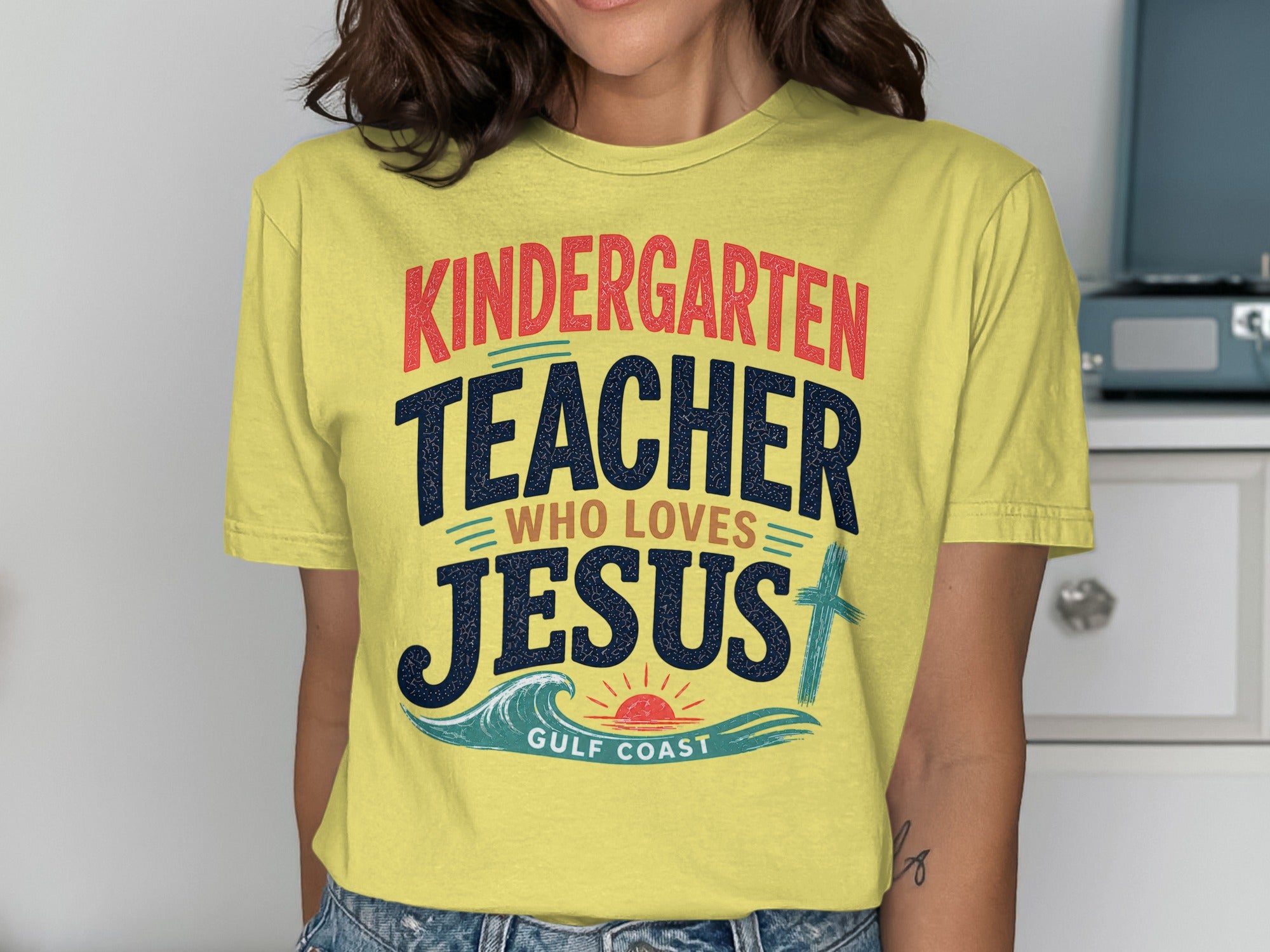 Yellow t-shirt with "Kindergarten Teacher Who Loves Jesus" and "Gulf Coast" text.