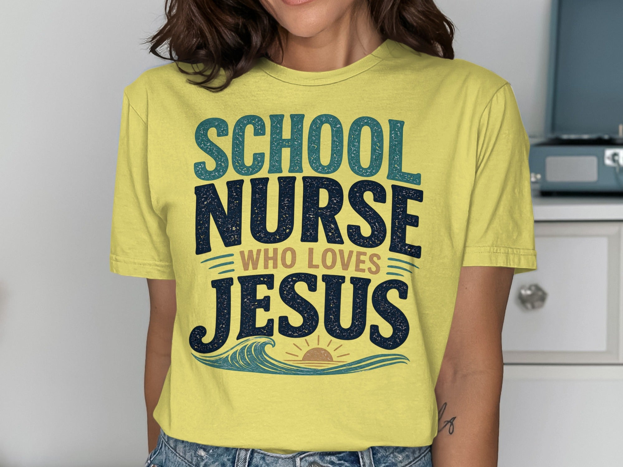 Yellow t-shirt with "School Nurse Who Loves Jesus" text and wave graphic.