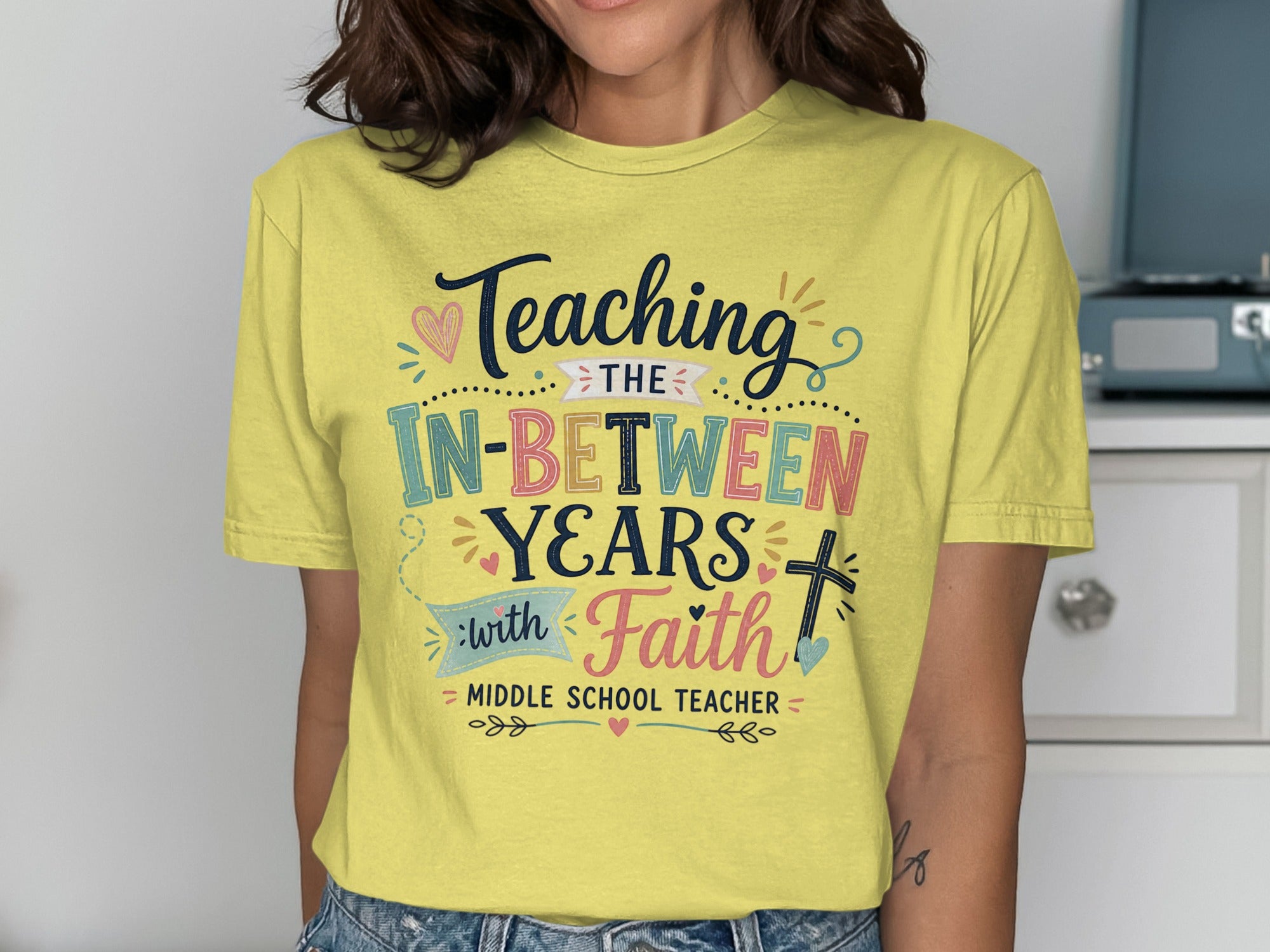 Yellow t-shirt with "Teaching in-between years with faith" and "middle school teacher."