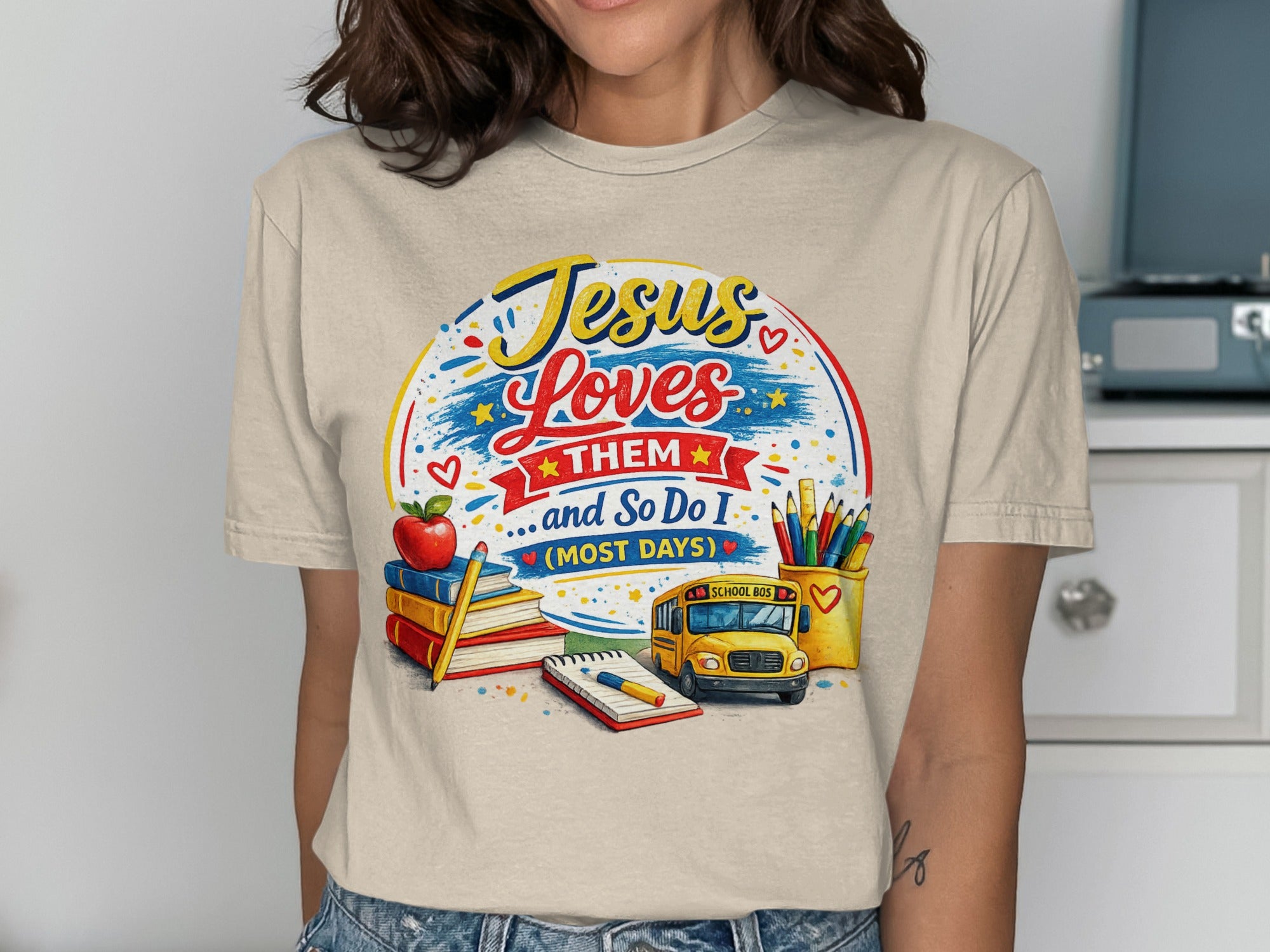 Jesus Loves Them shirt with school bus, pencils, and books.
